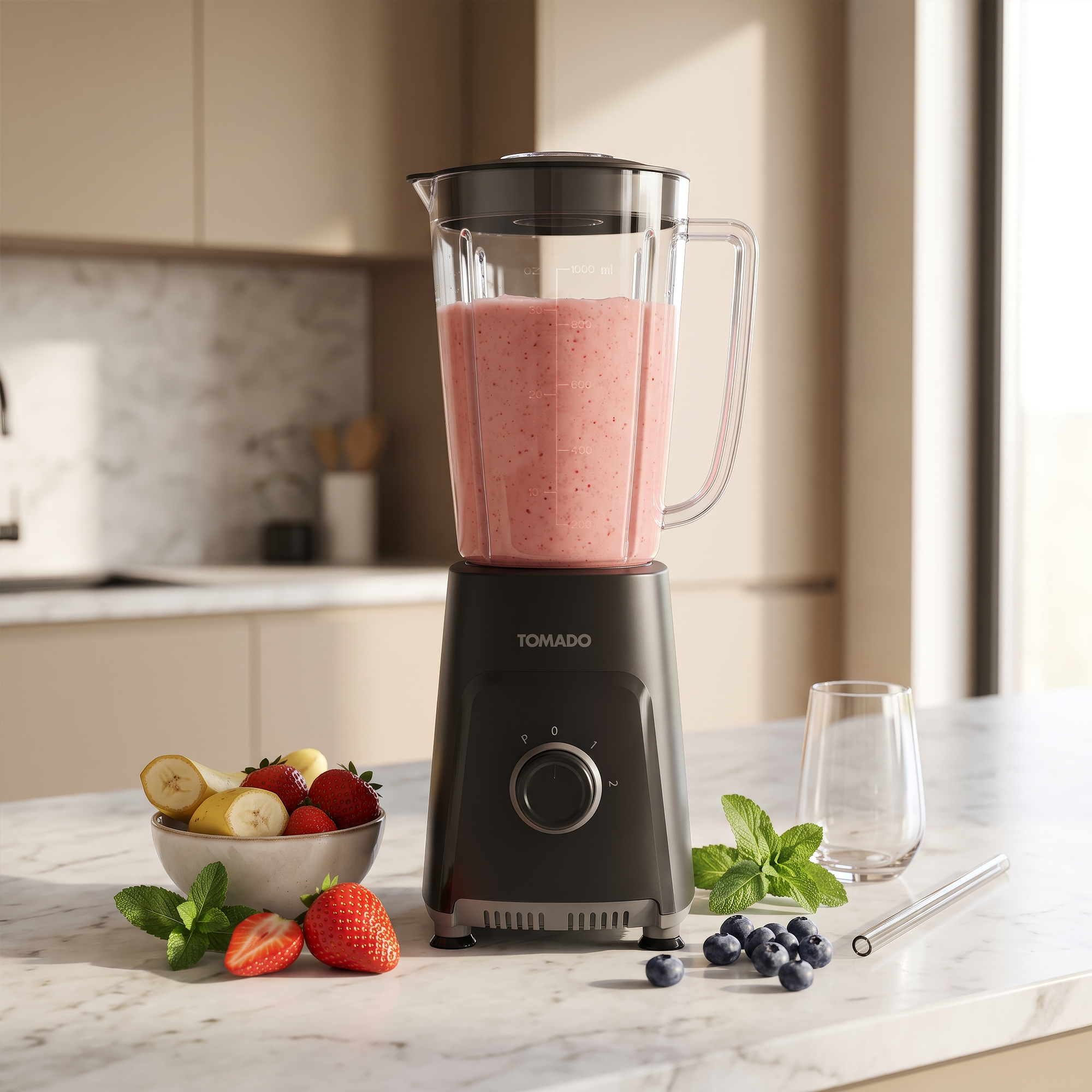 A black Tomado blender filled with pink smoothie stands on a marble counter with strawberries, blueberries, and mint.