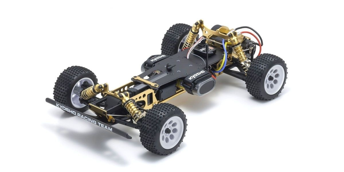 Ein gold-schwarzes RC-Buggy-Chassis mit weißen Rädern und Stollenreifen vor weißem Hintergrund.