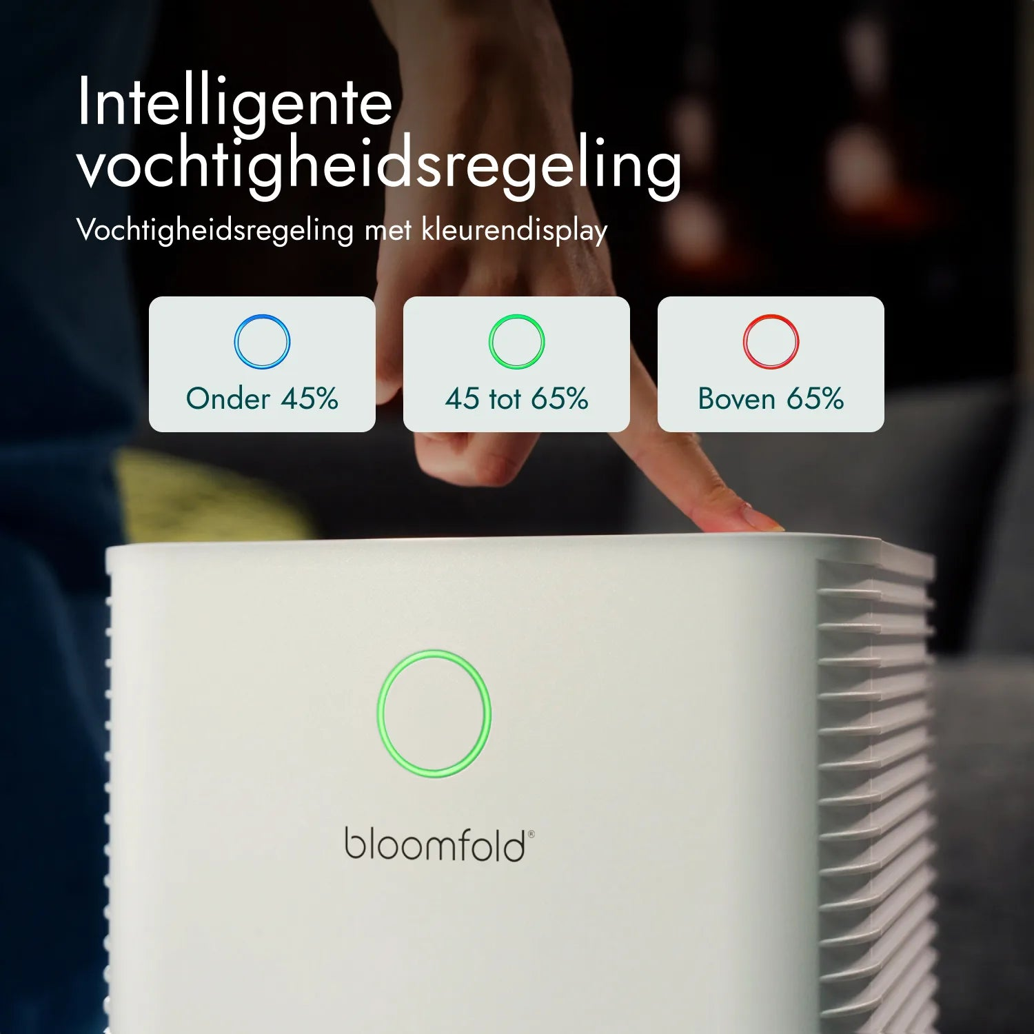 Eine Person berührt ein weißes Bloomfold-Luftgerät mit leuchtend grüner Anzeige.