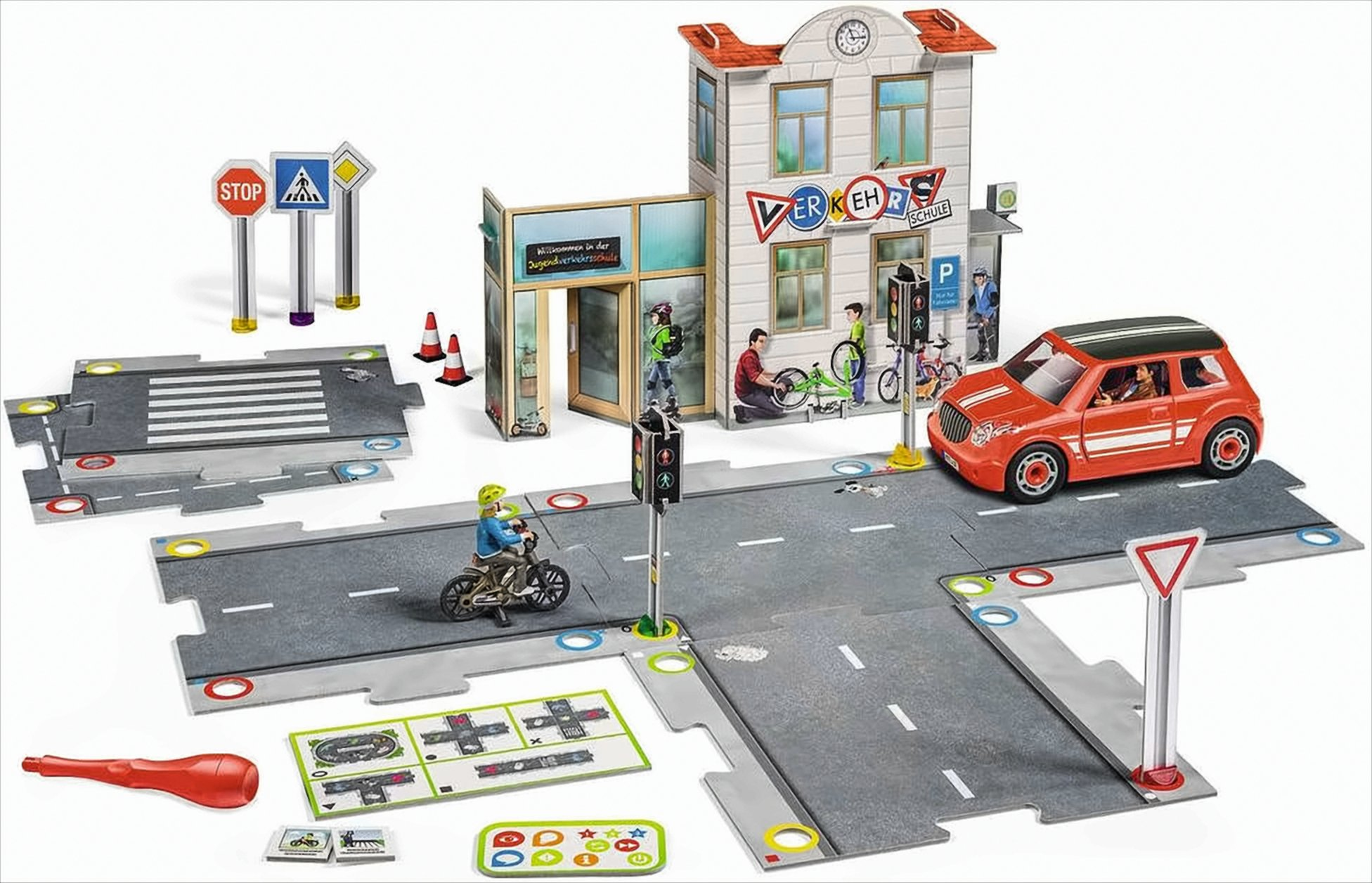 Ein Spielzeug-Verkehrsschulset mit Straßen, einem Gebäude, Verkehrsschildern, einem roten Auto und einem Kind auf einem Fahrrad.