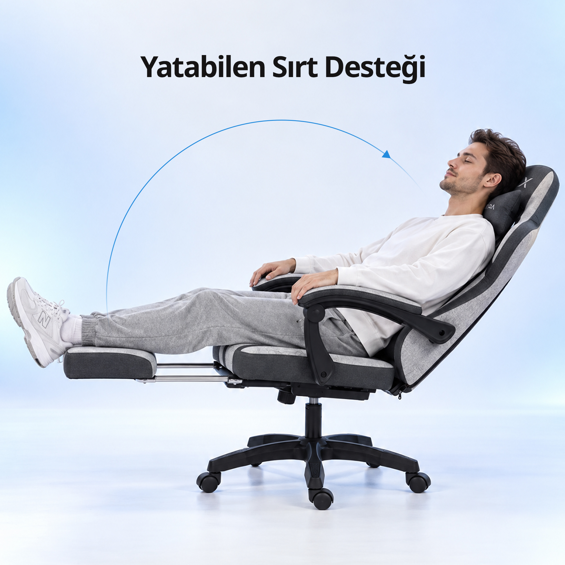 Ayak dayama yerli gri beyaz yatar ofis koltuğunda dinlenen bir adam.