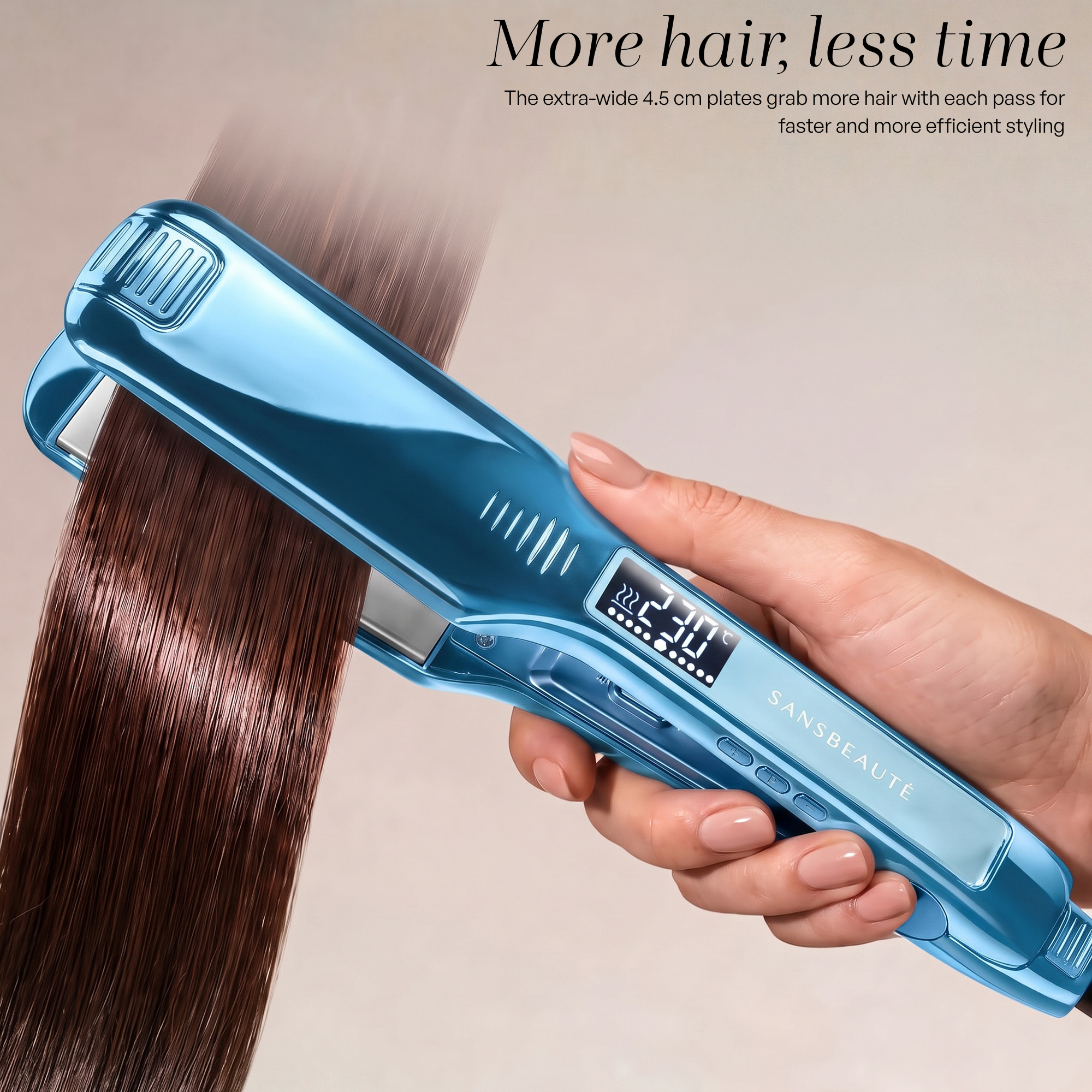 A hand holds a shiny blue hair straightener gliding through smooth brown hair.