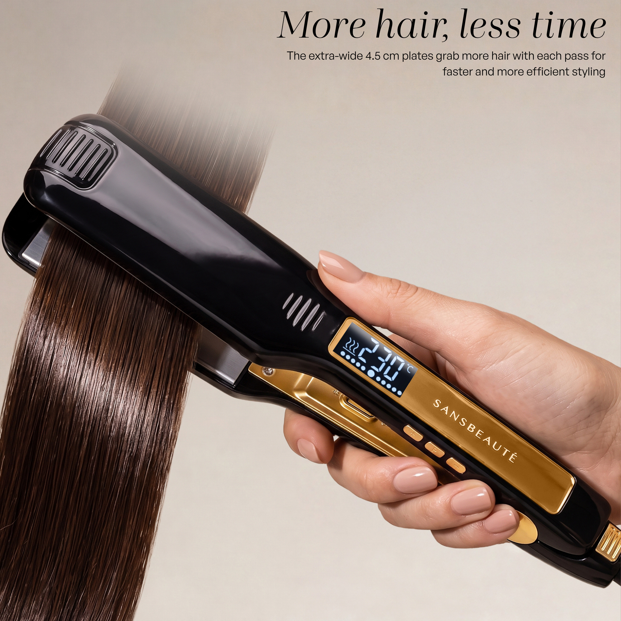 A hand holds a black and gold hair straightener gliding through sleek brown hair.
