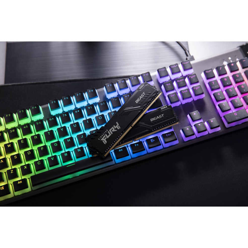 Dwa czarne moduły RAM DDR4 Kingston FURY spoczywające na klawiaturze gamingowej z podświetleniem RGB.