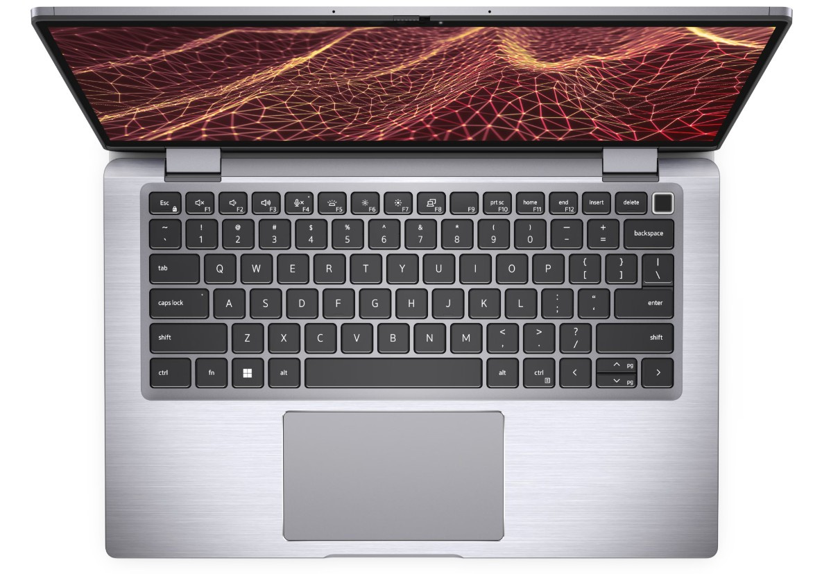 Widok z góry na srebrny laptop z podświetlanym ekranem i czarną klawiaturą.