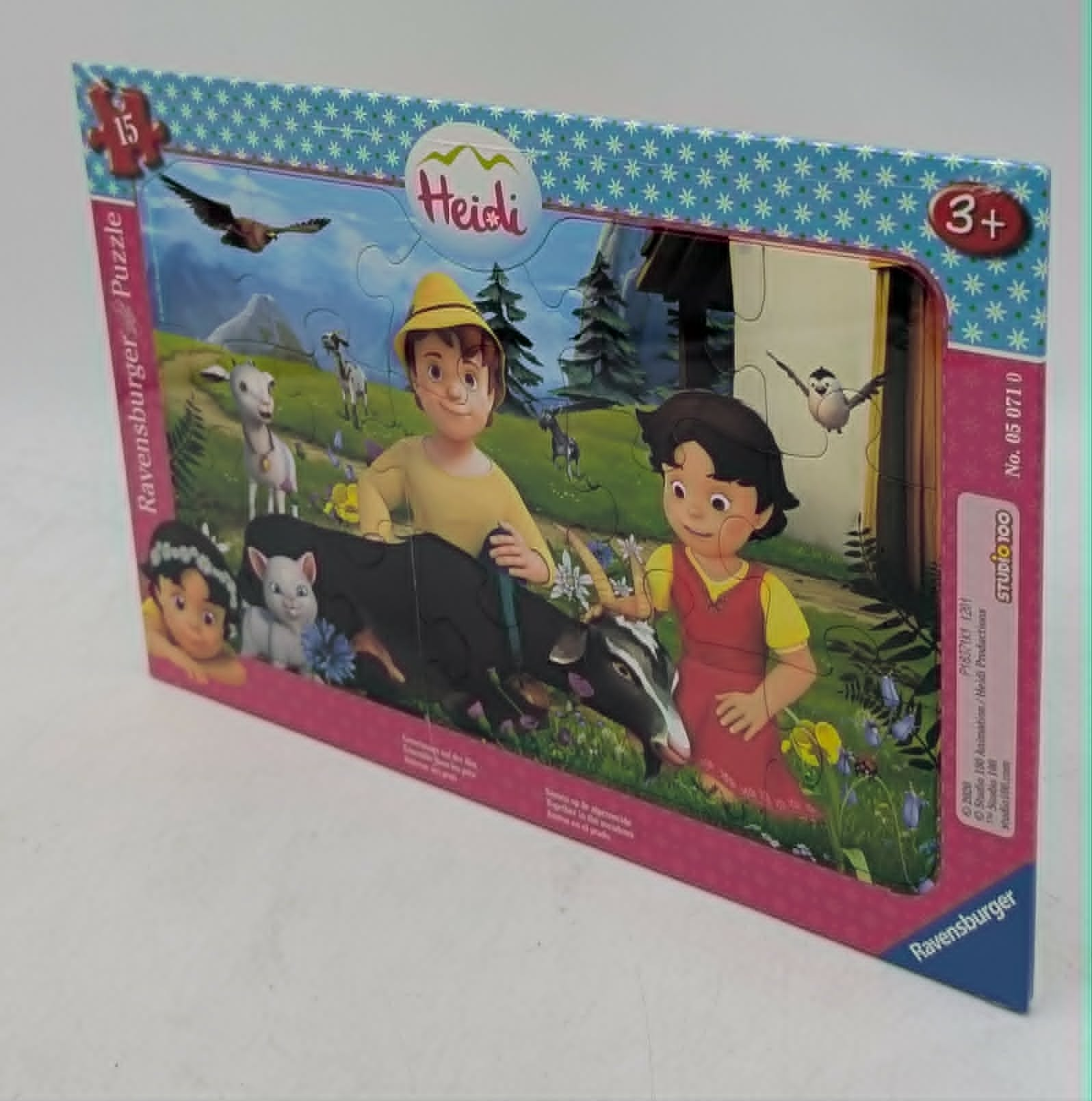 Ein 15-teiliges Ravensburger Heidi-Puzzle in Schachtel mit Heidi, Peter und Ziegen in einer Alpinlandschaft.