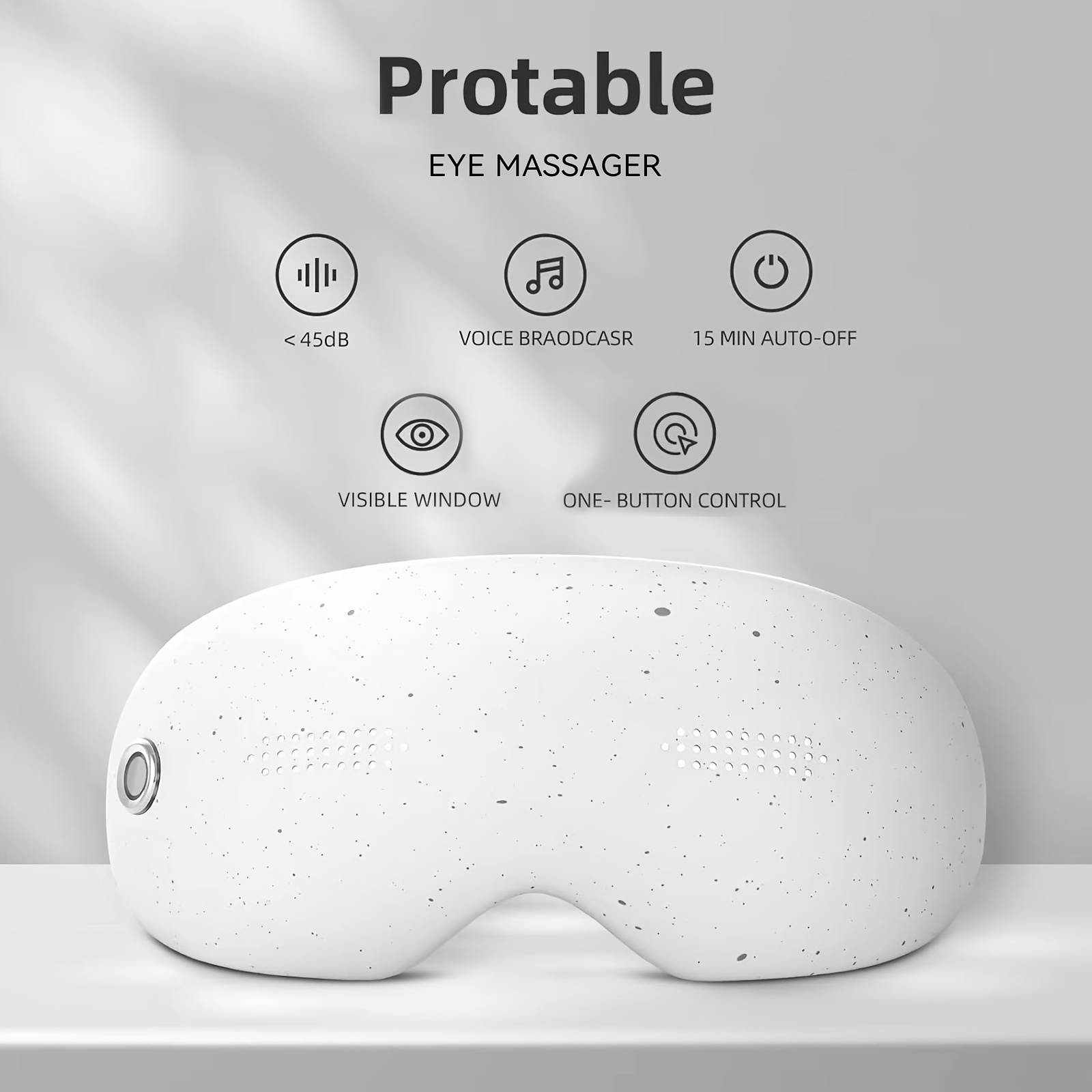 Ein weißer, gesprenkelter Augenmassager auf einer Ablage mit Icons für Funktionen darüber.