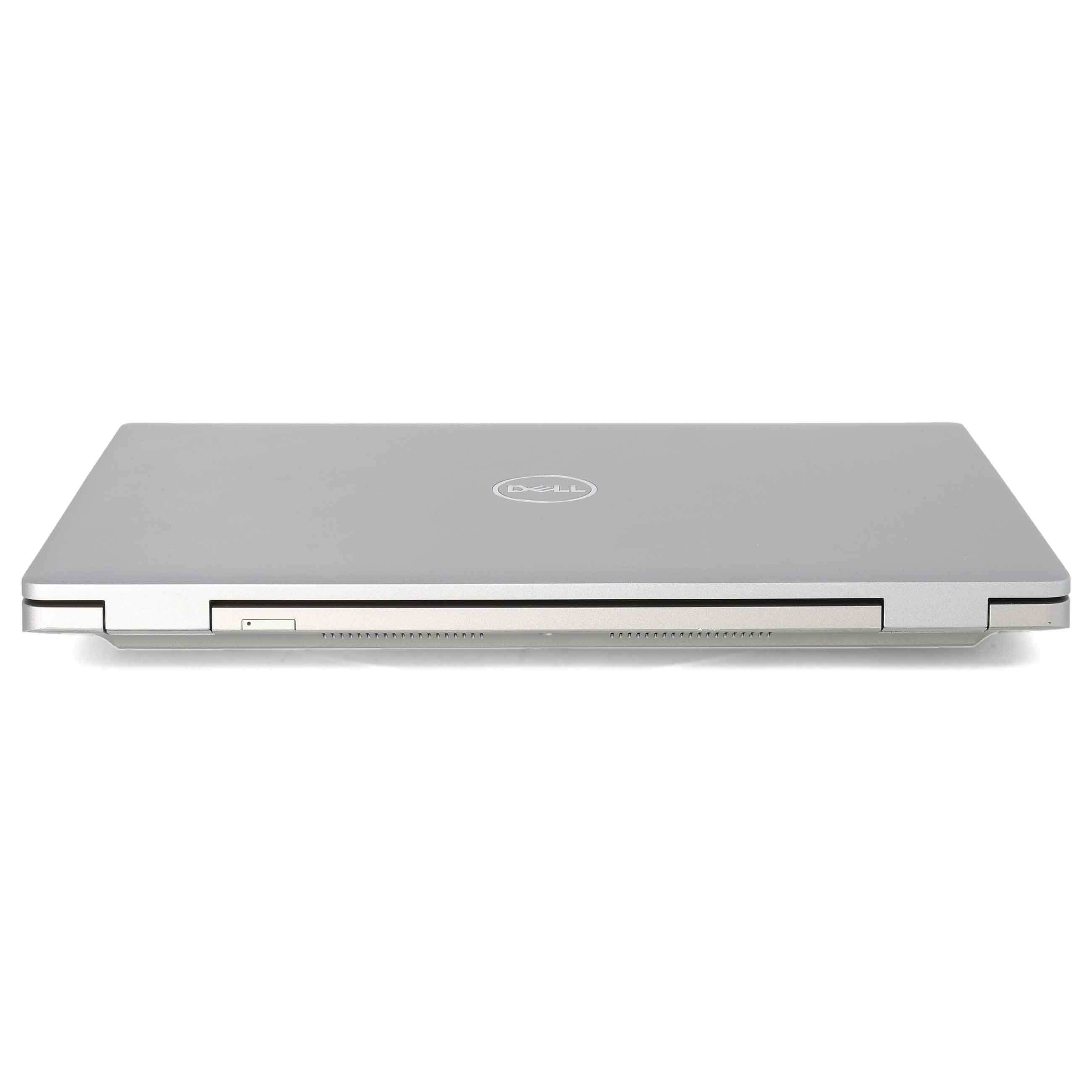 Ein silberner geschlossener Dell Laptop steht auf einer weißen Oberfläche mit sichtbarem Logo.