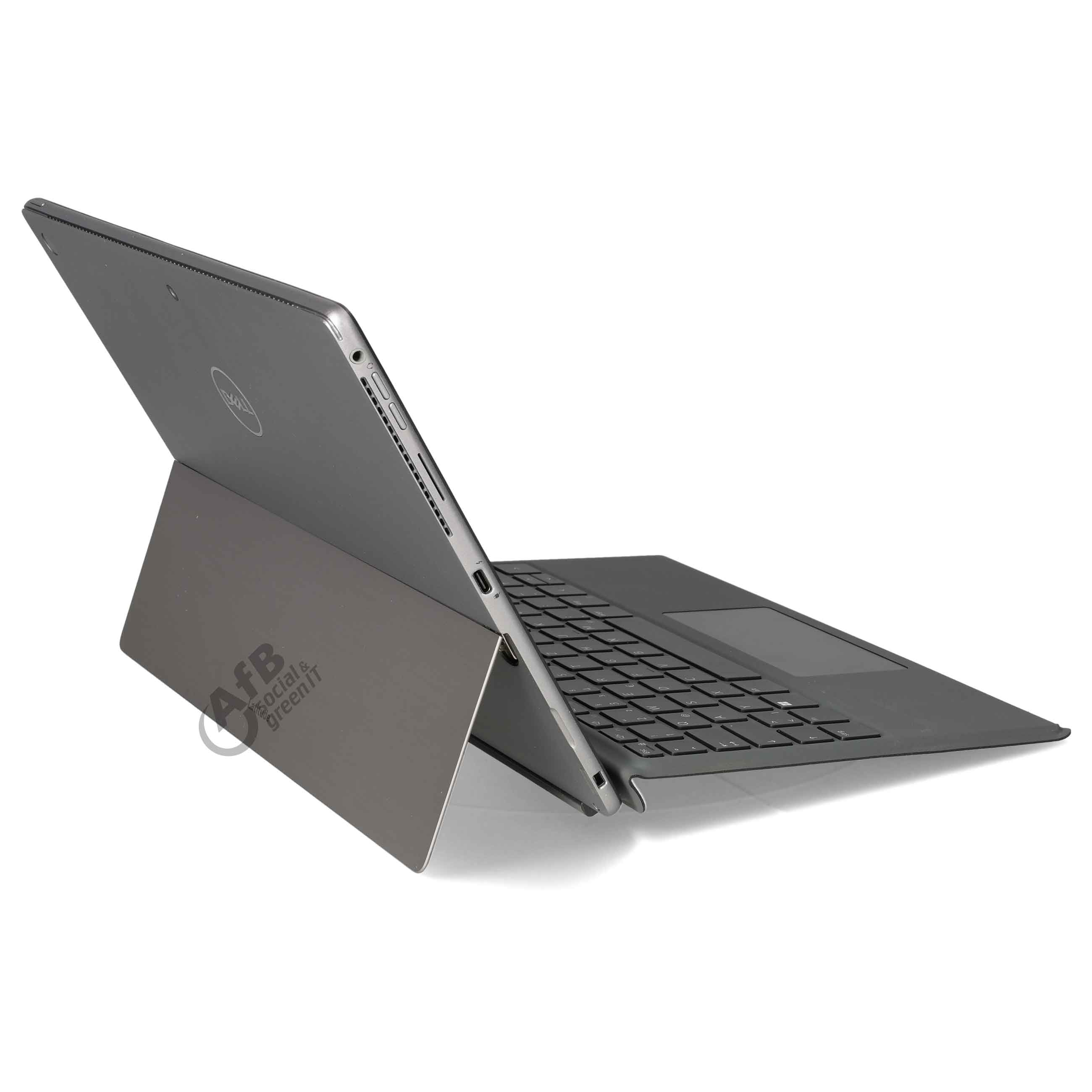 Ein graues Tablet mit angeschlossener Tastatur und Ständer auf weißem Hintergrund, seitlich betrachtet.