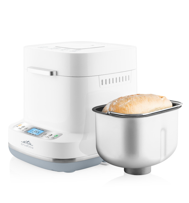 Weißer Brotbackautomat mit digitalem Display und herausnehmbarer Backform gefüllt mit frisch gebackenem Brot.
