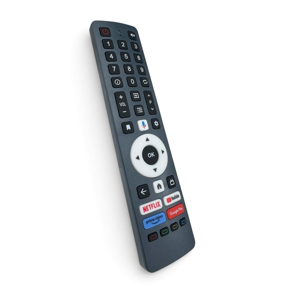 Beyaz arka planda sayı tuşları ve Netflix, YouTube, Prime Video kısayolları olan gri renkli bir uzaktan kumanda.