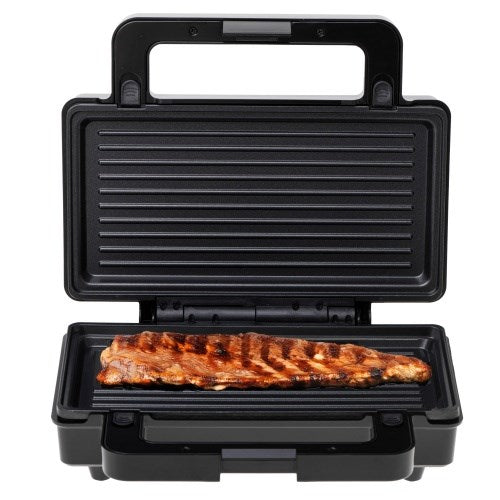 Czarny grill stołowy z otwartą pokrywą opieka pojedynczy kawałek mięsa na żebrowanej powierzchni.