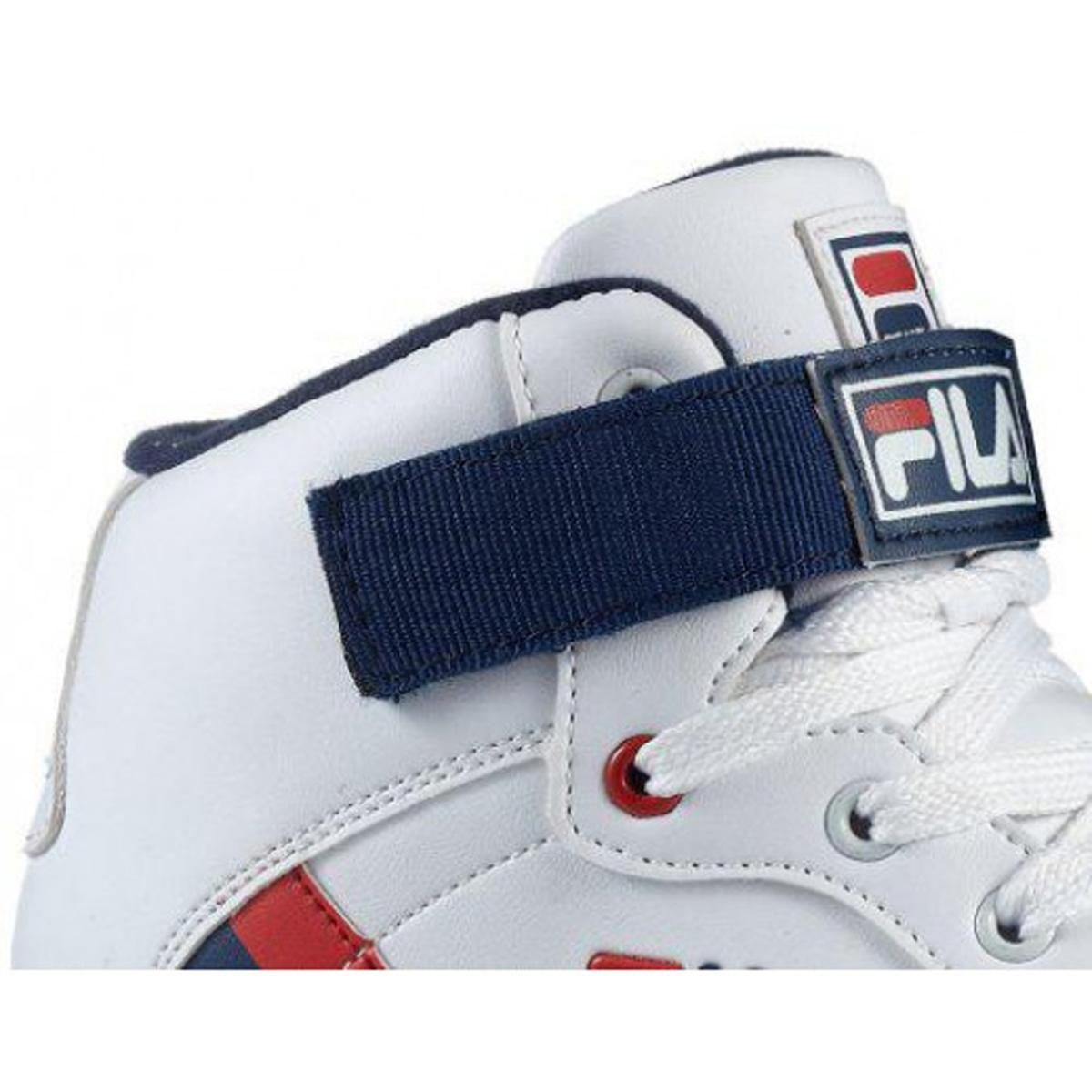 Nahaufnahme eines weißen Fila-Sneakers mit blauem Riemen und rotem Logo.
