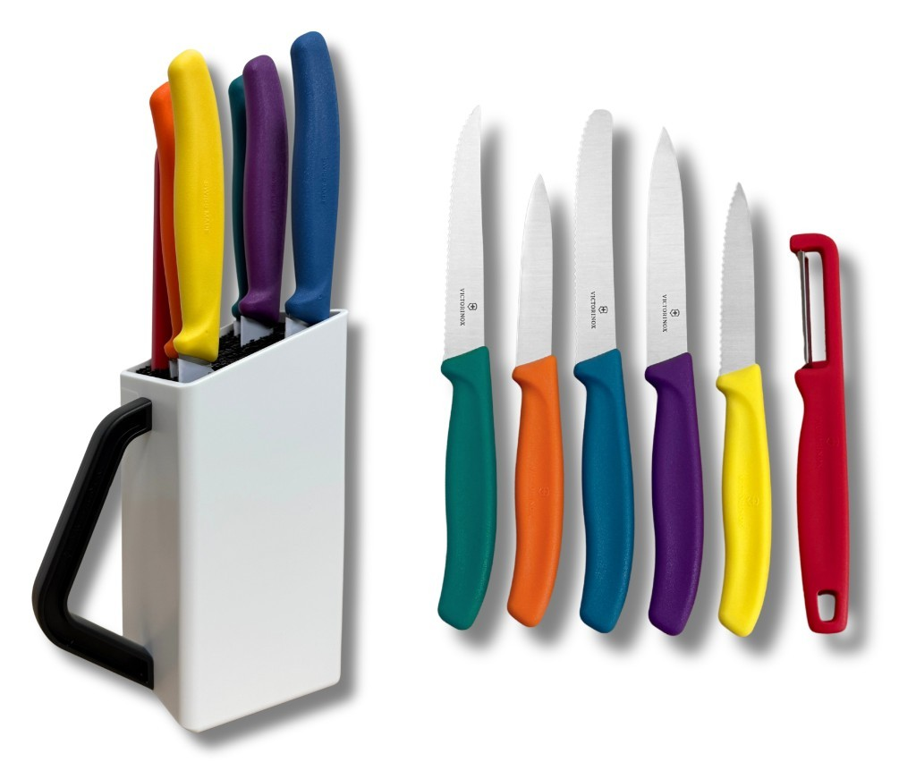 Un bloque de cuchillos blanco con mangos de colores, y seis cuchillos y un pelador colocados al lado.