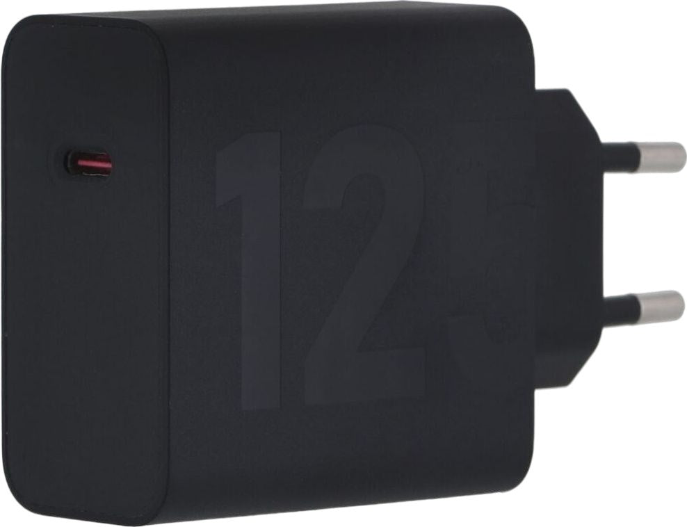 A black USB-C wall charger with rounded corners and plug pins on a white background.