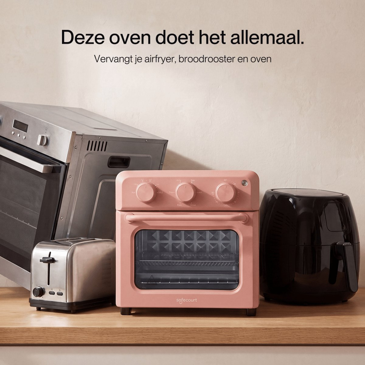 A pink oven on a counter next to a toaster, microwave, and air fryer, with Dutch promotional text.