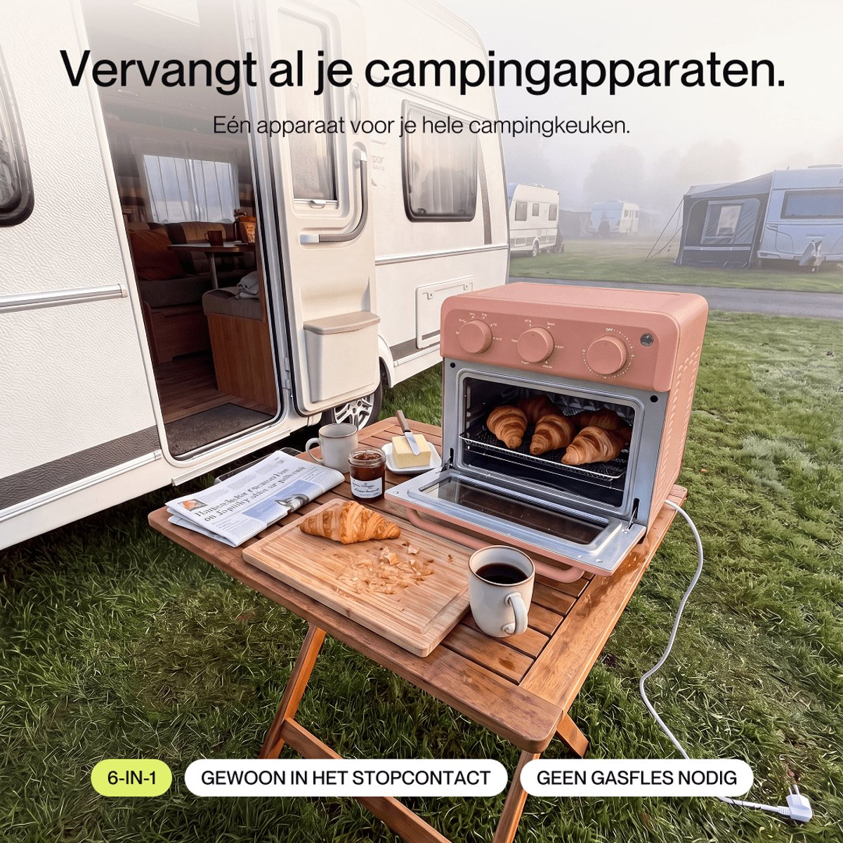 A pink mini oven on a wooden table outside a camper, with croissants, coffee, and Dutch text above and below.