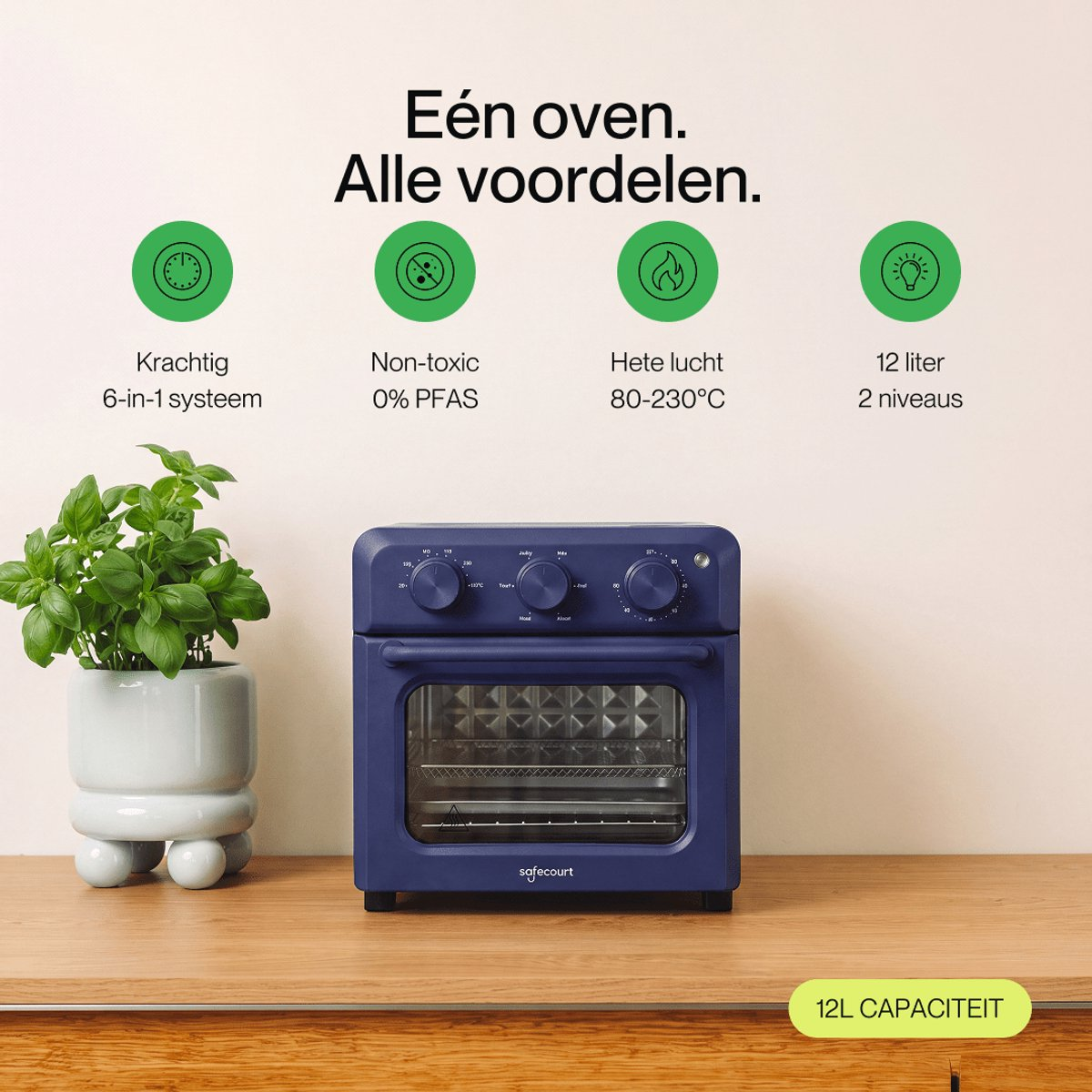 A blue oven on a wooden table next to a potted plant, with four green feature icons above.