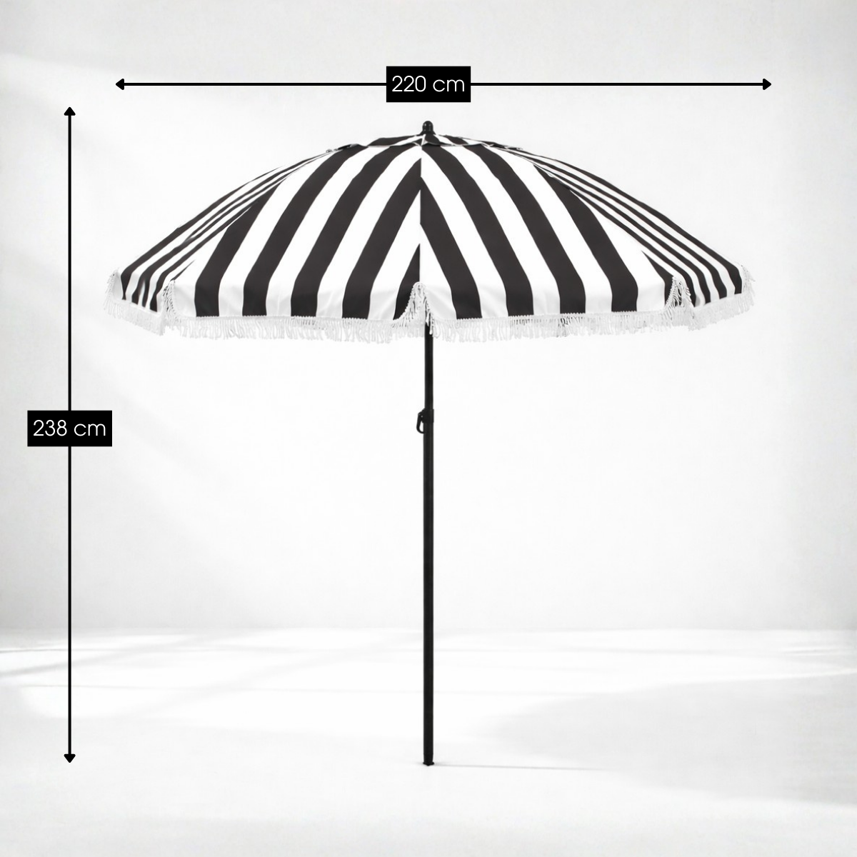Black and white striped parasol with fringe, height 238 cm and width 220 cm.