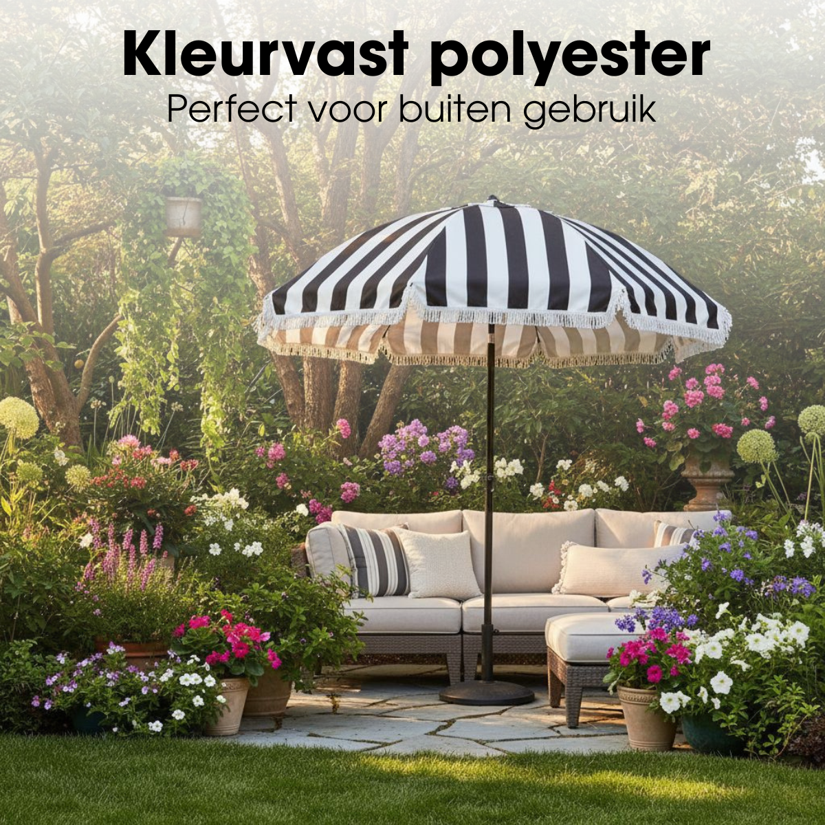 A black and white striped parasol stands over a beige outdoor sofa in a lush, flower-filled garden.