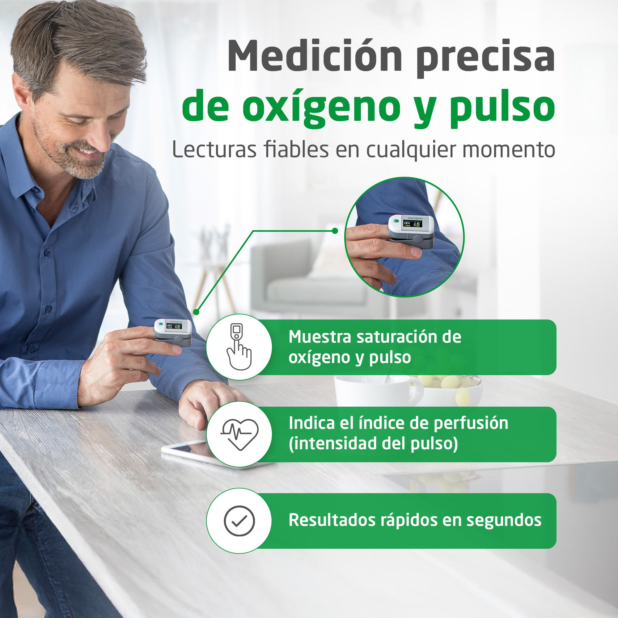 A man measures his pulse with an oximeter at a table.