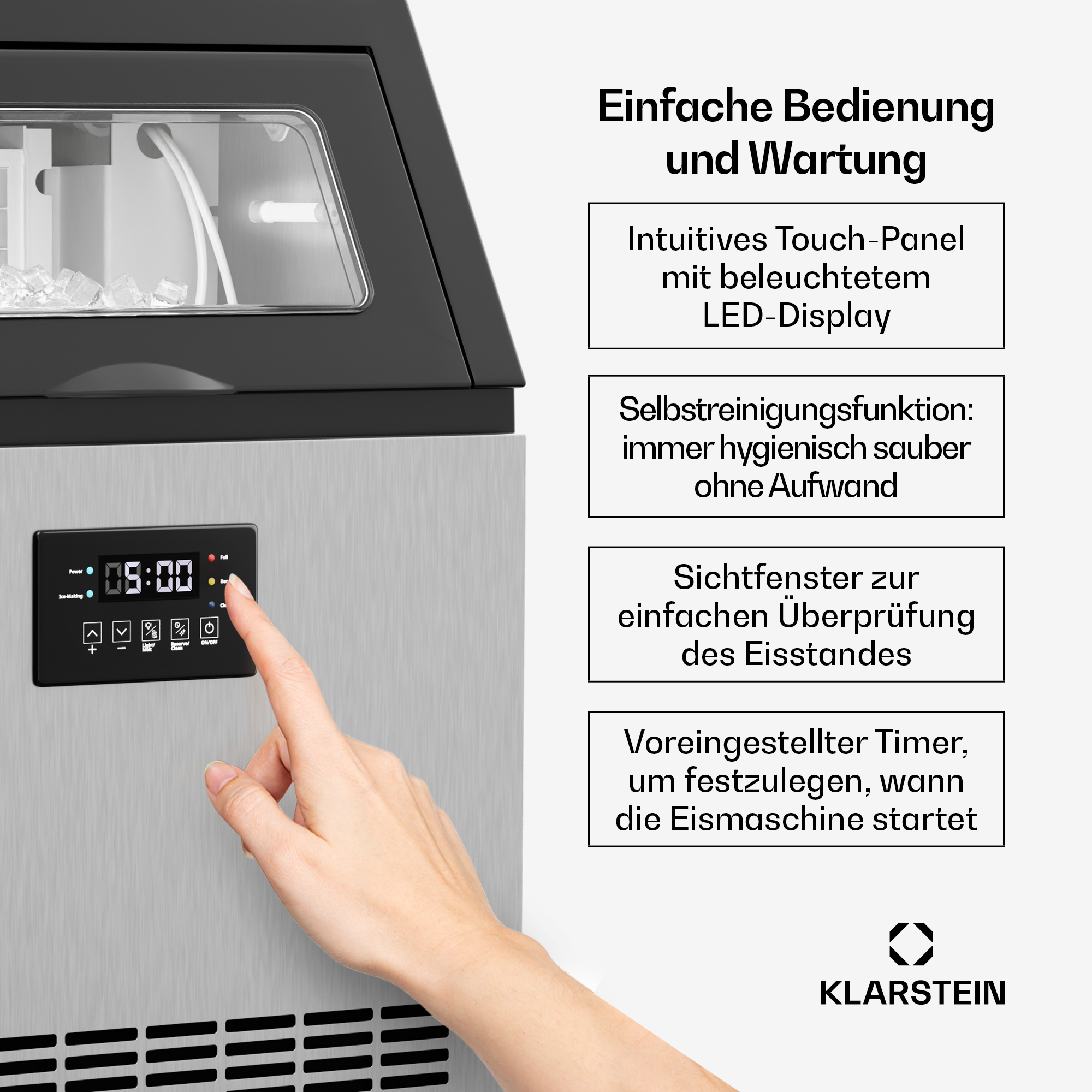 Hand bedient das Touchpanel eines silbernen Eisbereiters mit LED-Anzeige und Texthinweisen zur Bedienung.
