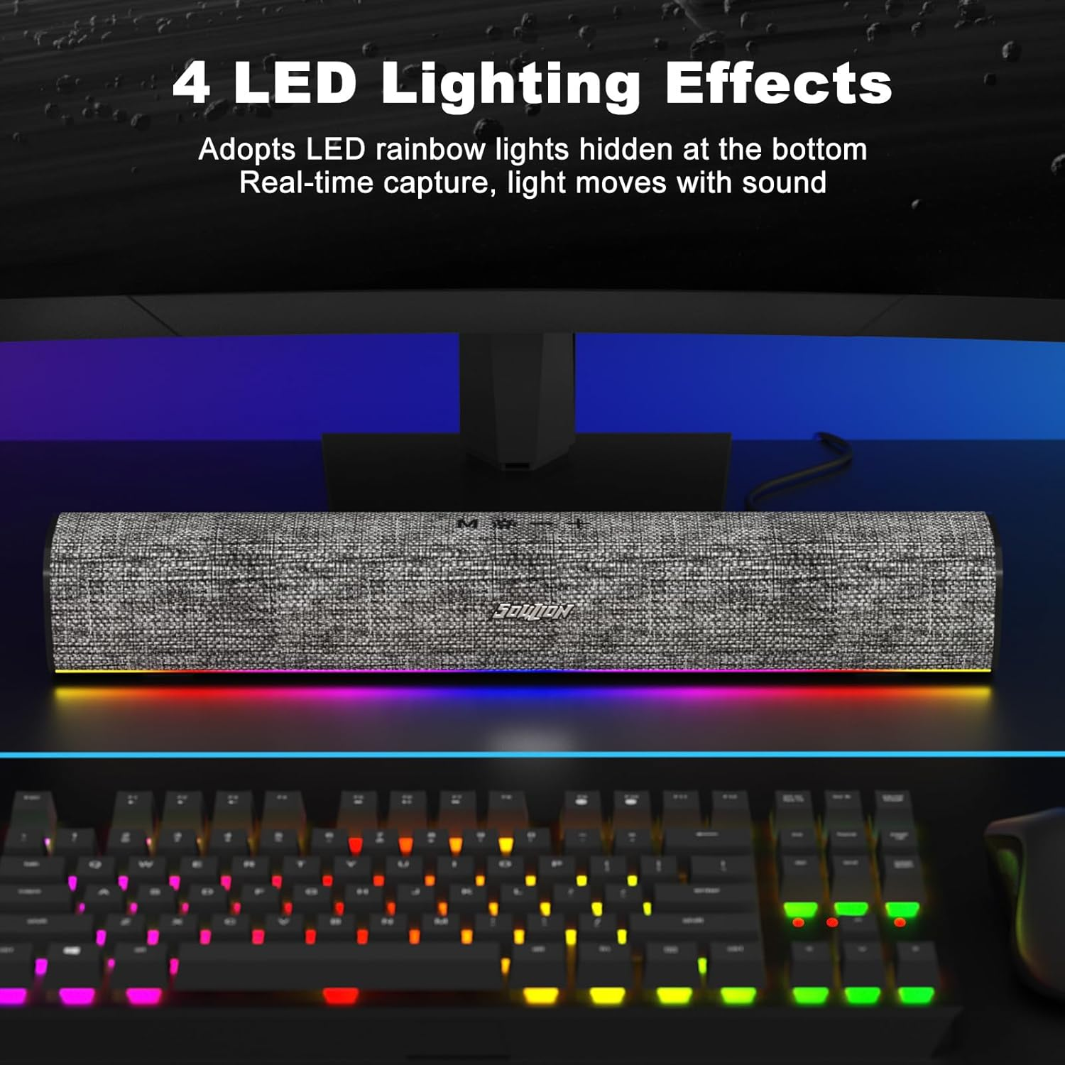 Eine Stoff-Soundbar mit bunten LED-Lichtern darunter, platziert auf einem Schreibtisch vor einer Tastatur.