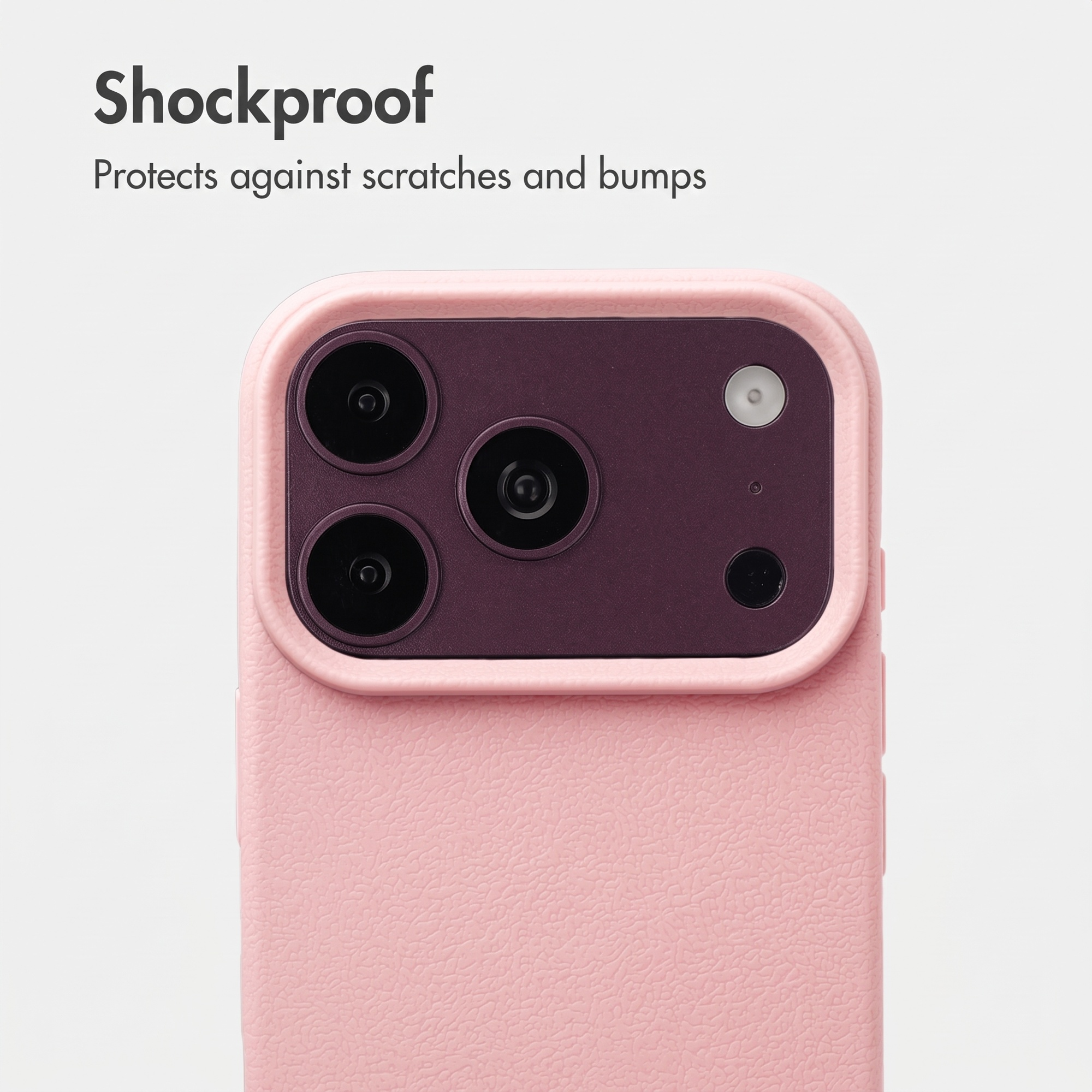 Coque rose avec bloc photo violet foncé, trois objectifs, texte antichoc.