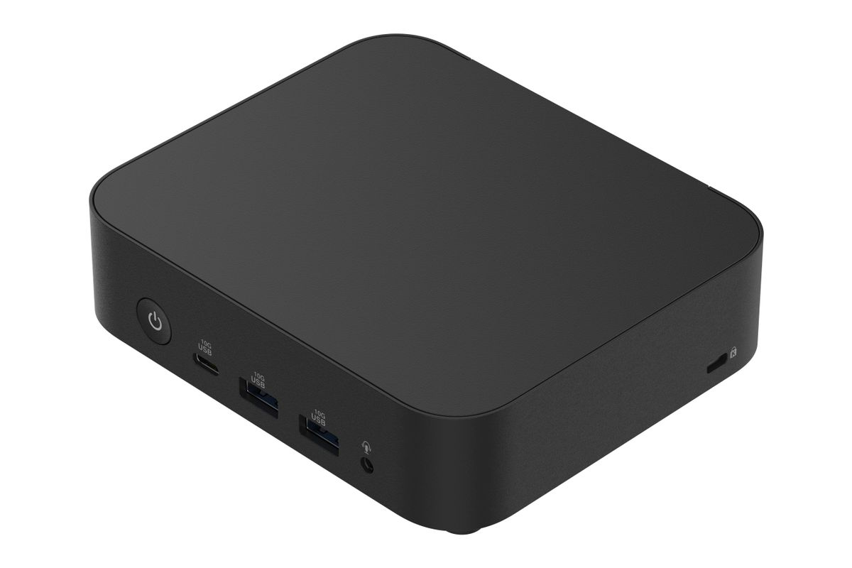 Un mini PC negro compacto con esquinas redondeadas, puertos USB frontales, conector de audio y botón de encendido.