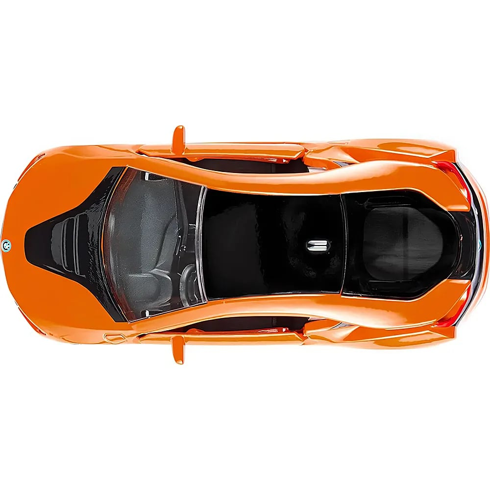 Draufsicht auf ein glänzendes orangefarbenes Spielzeugauto mit schwarzem Dach und Fenstern.