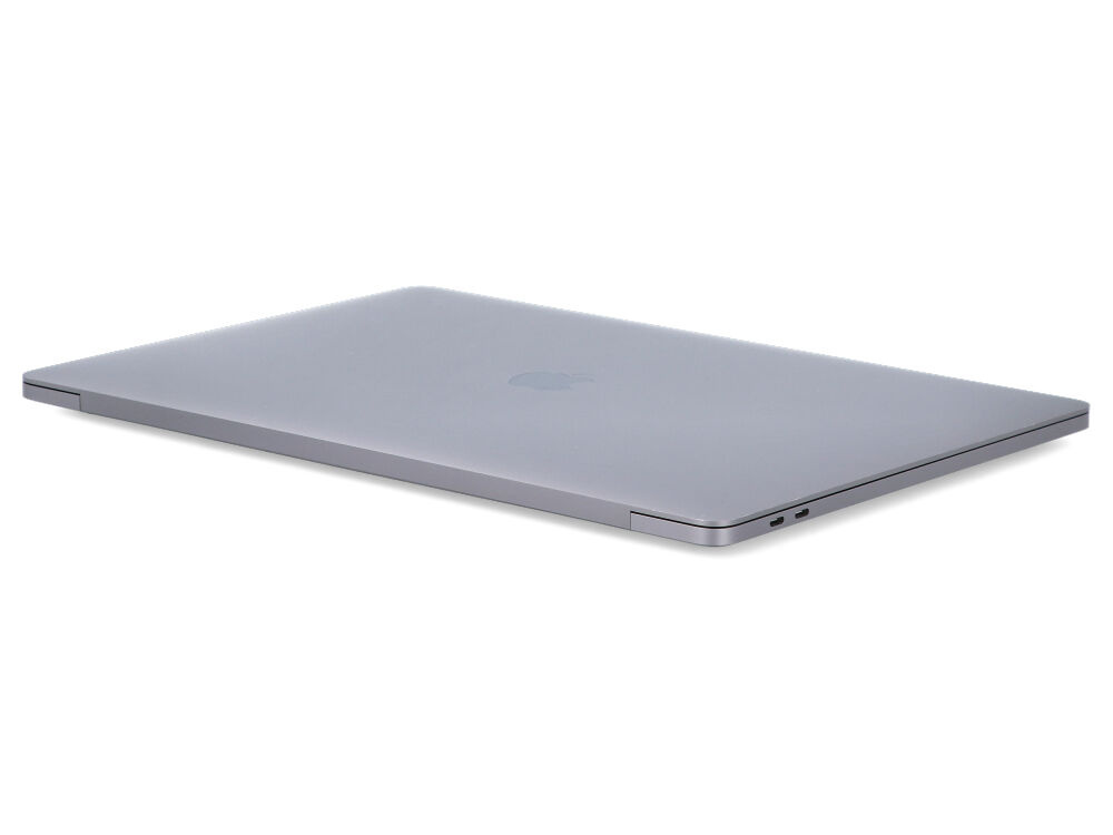 Zamknięty szary laptop na białej powierzchni.