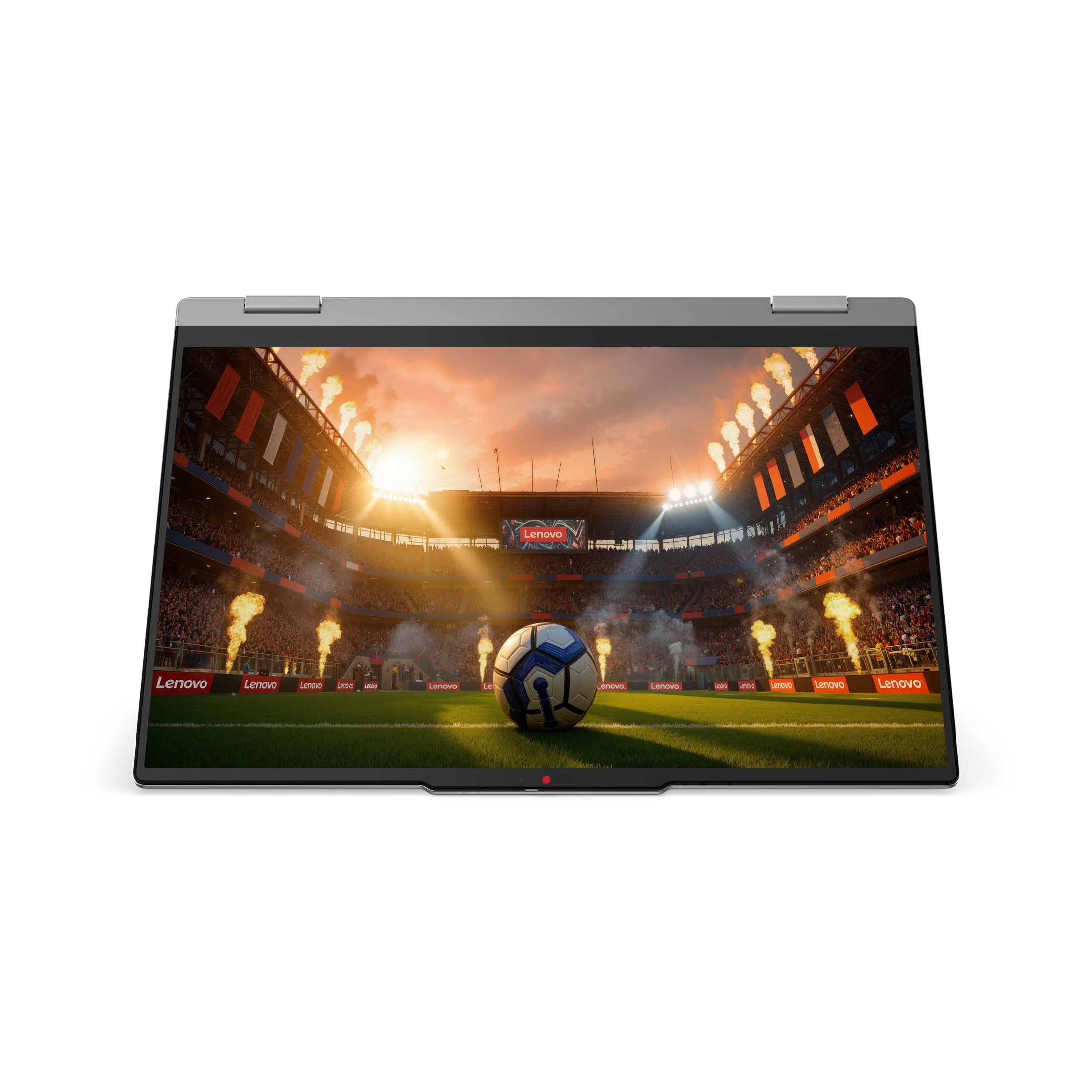 Ein Laptop zeigt ein Fußballspiel im Stadion mit brennenden Feuerfontänen und einer jubelnden Menschenmenge.