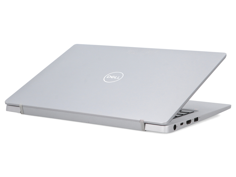 Srebrny laptop Dell z zamkniętą pokrywą na białym tle, widoczne porty boczne.
