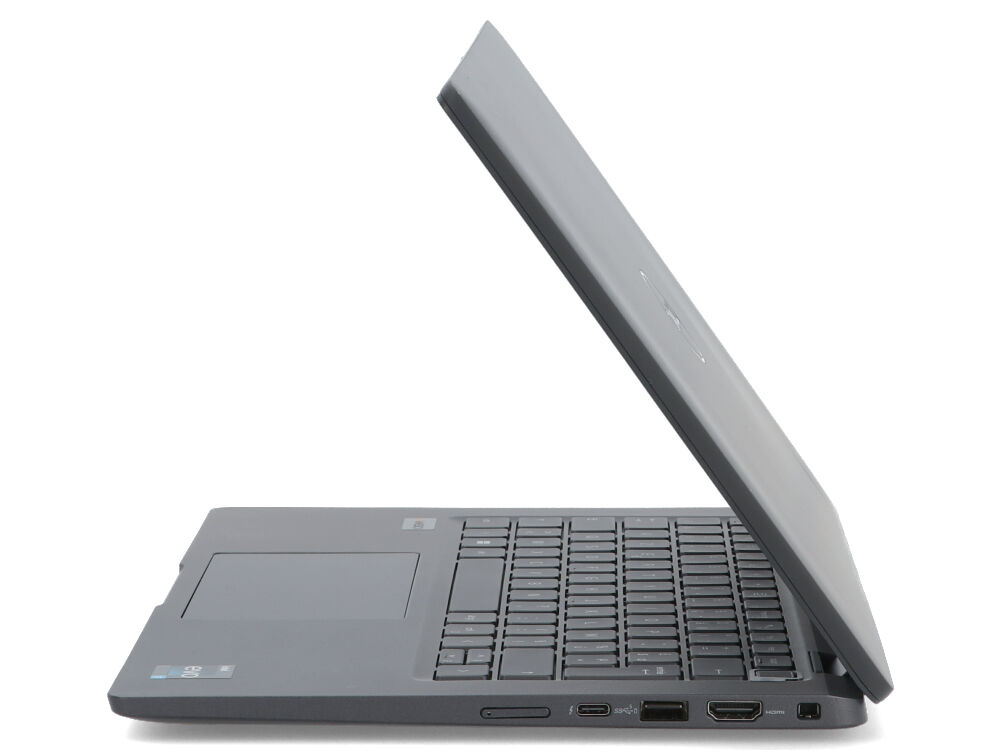 Szary laptop jest pokazany z profilu, z częściowo otwartym ekranem, ujawniając klawiaturę i porty.