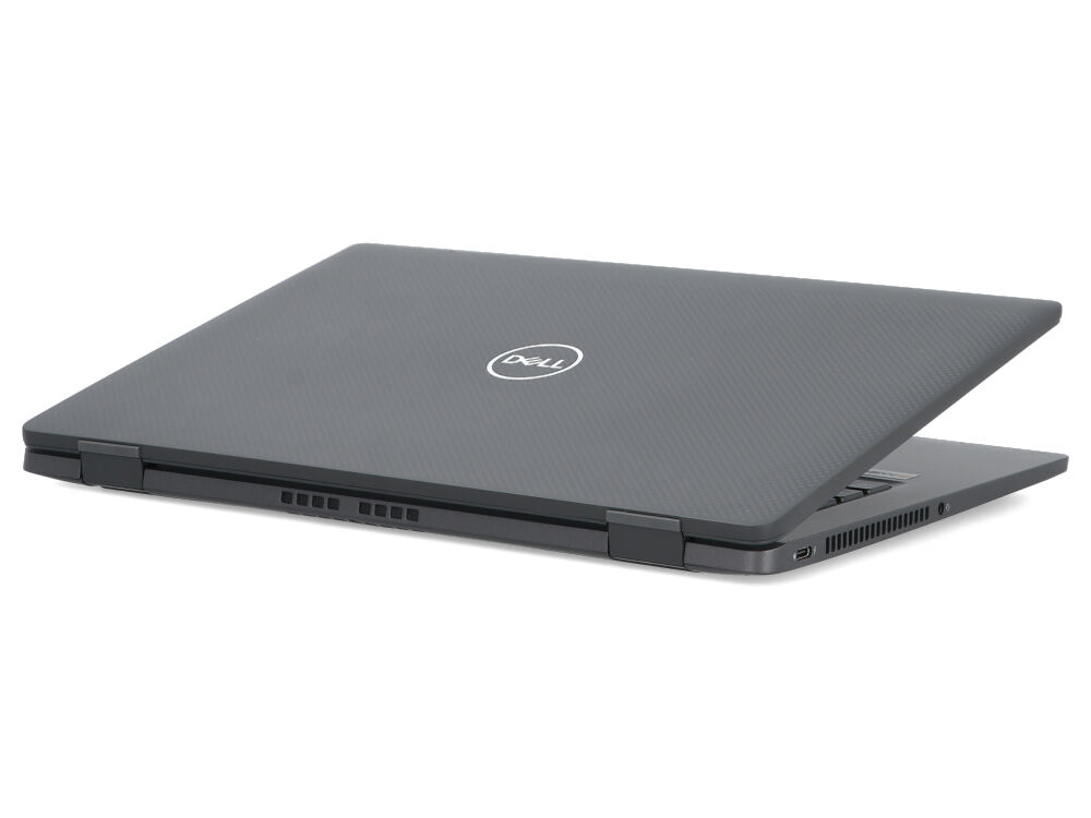 Zamknięty szary laptop Dell z teksturowaną powierzchnią i białym logo na białym tle.