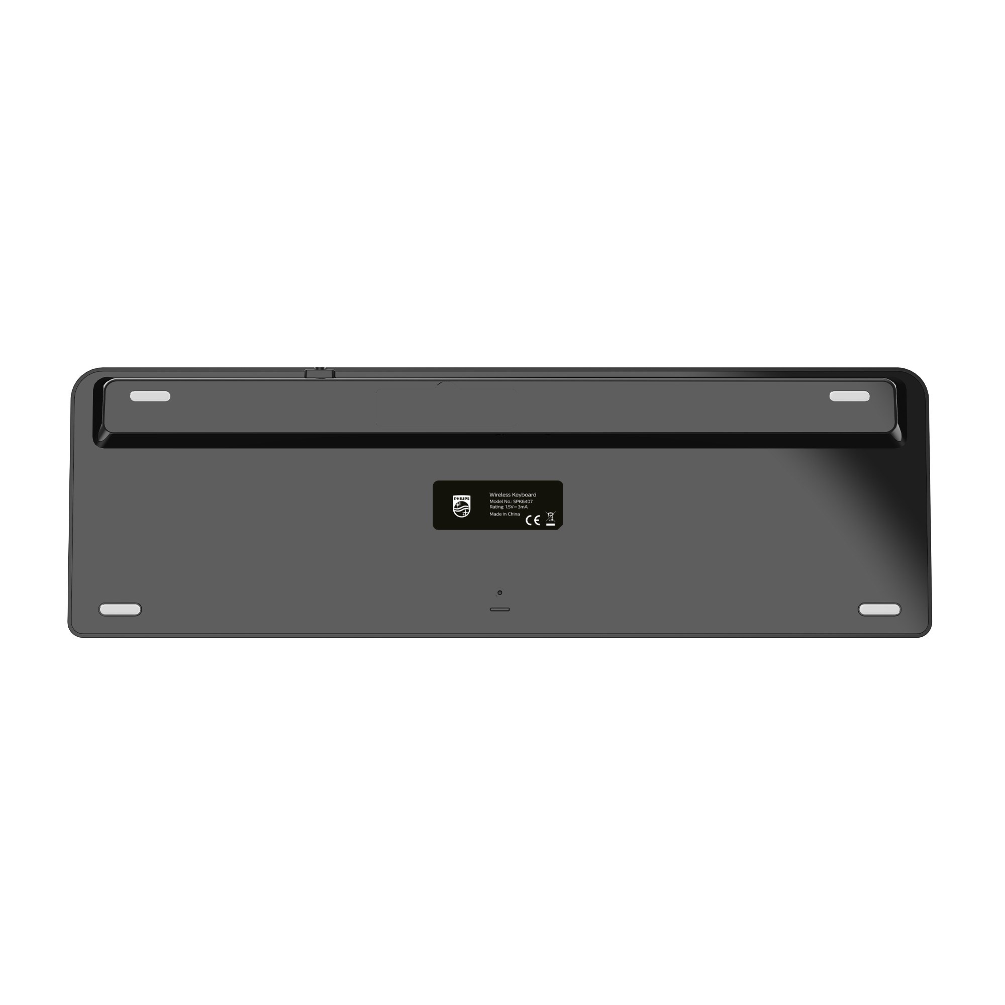 Kauçuk ayaklar, pil bölmesi ve ürün etiketini gösteren siyah bir Philips kablosuz klavyenin alt görünümü.