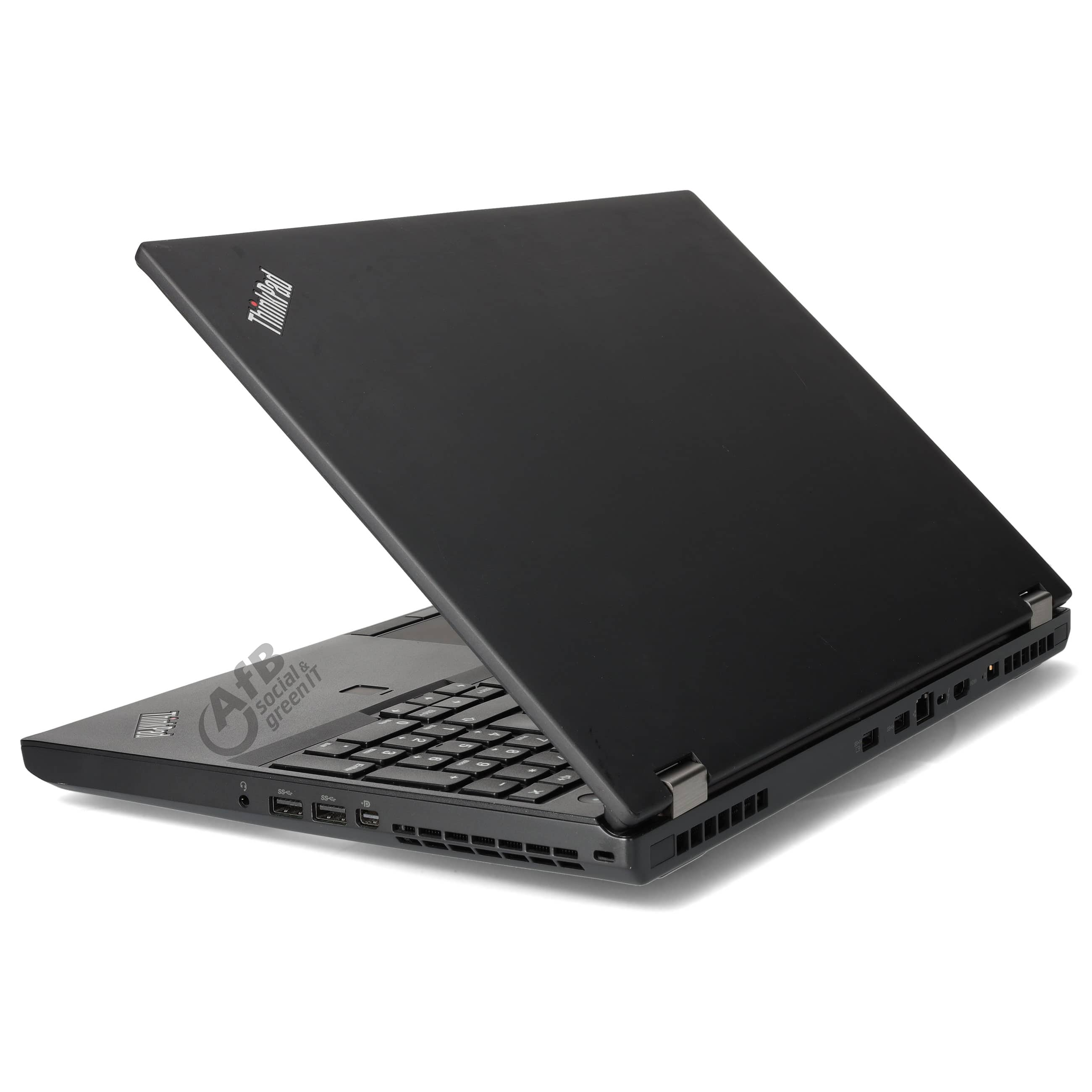 Ein geschlossener schwarzer Laptop steht auf einer weißen Oberfläche mit sichtbaren Anschlüssen.