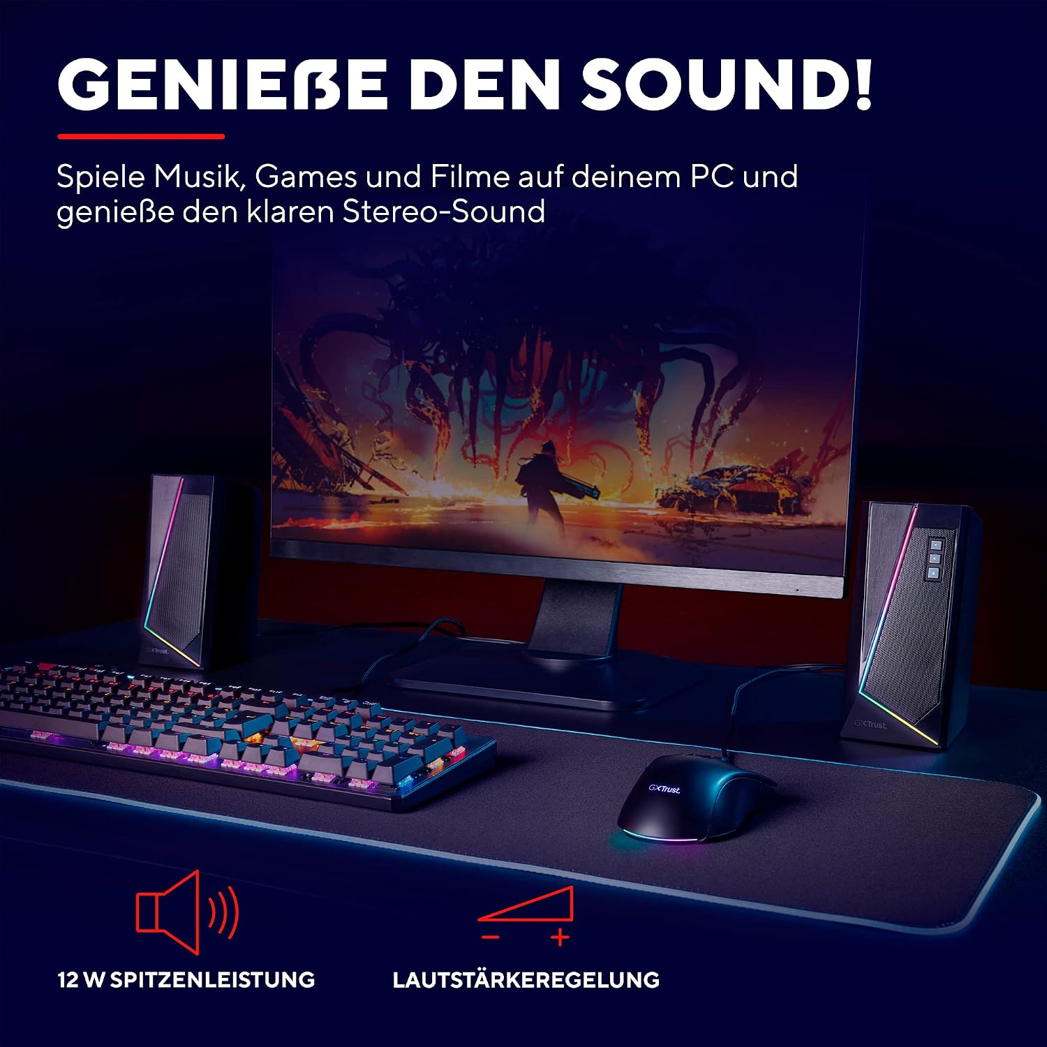 Escritorio de juegos con monitor, altavoces iluminados, teclado y ratón en una alfombrilla.