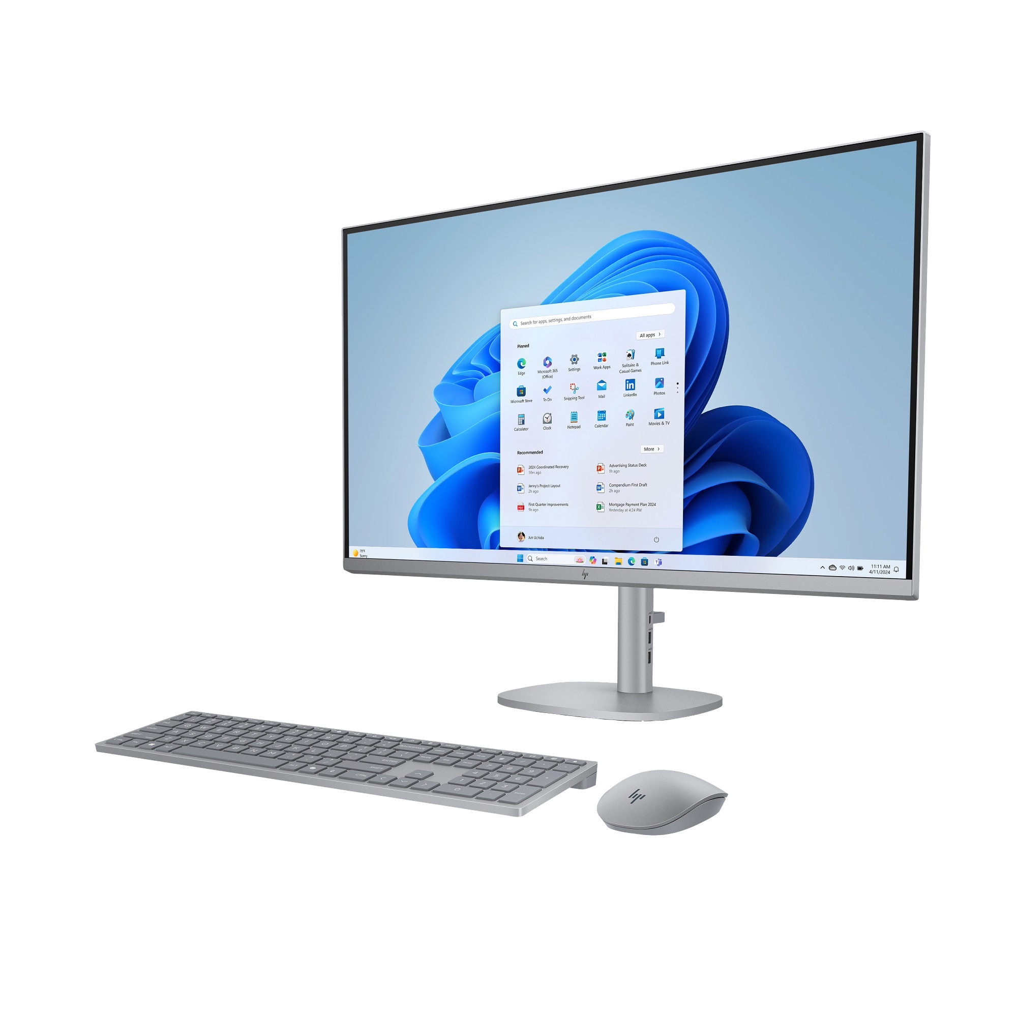 Una computadora todo en uno plateada con monitor, teclado inalambrico y Raton sobre fondo blanco.