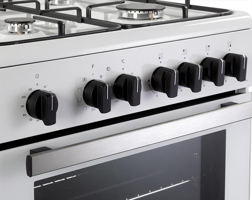 Primo piano di una stufa bianca con manopole di controllo nere e maniglia del forno in acciaio.