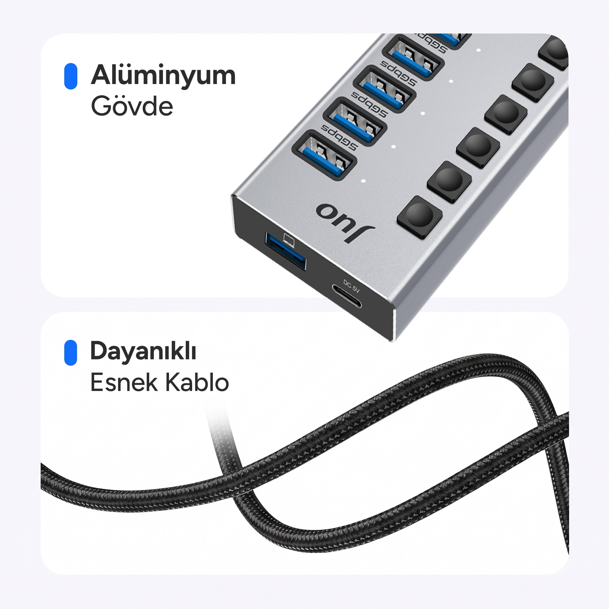 Çoklu port ve anahtarlara sahip gümüş renkli bir USB çoklayıcı ve altında dayanıklı siyah kablo.