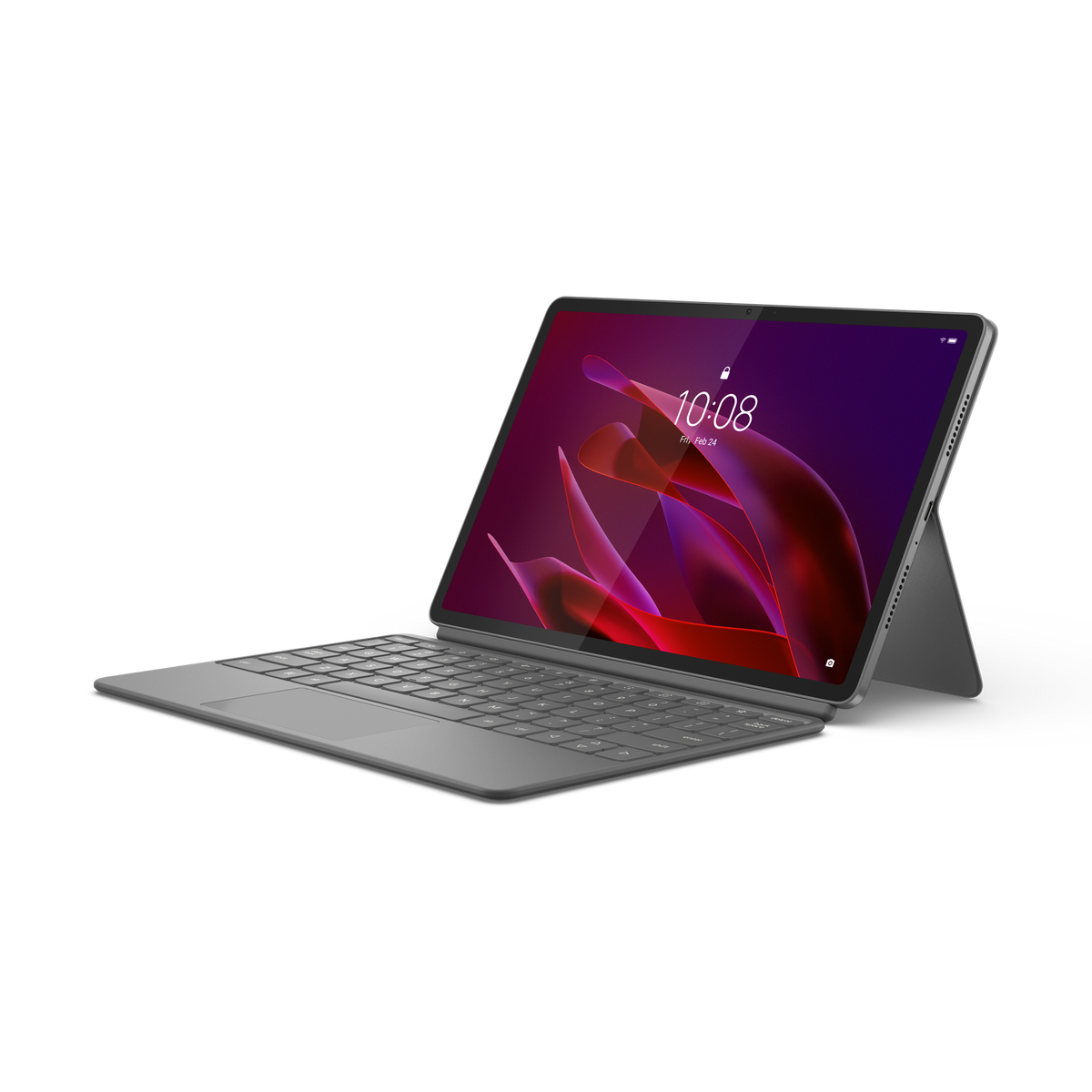 Una tableta gris con un teclado acoplado sobre una superficie blanca, la pantalla muestra un patrón abstracto rojo.