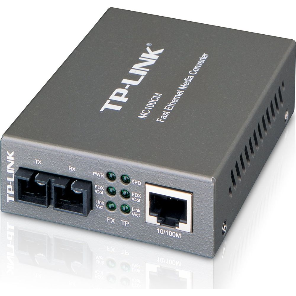 Un convertitore multimediale fast ethernet TP-Link grigio con porte, spie luminose e marchio su superficie bianca.