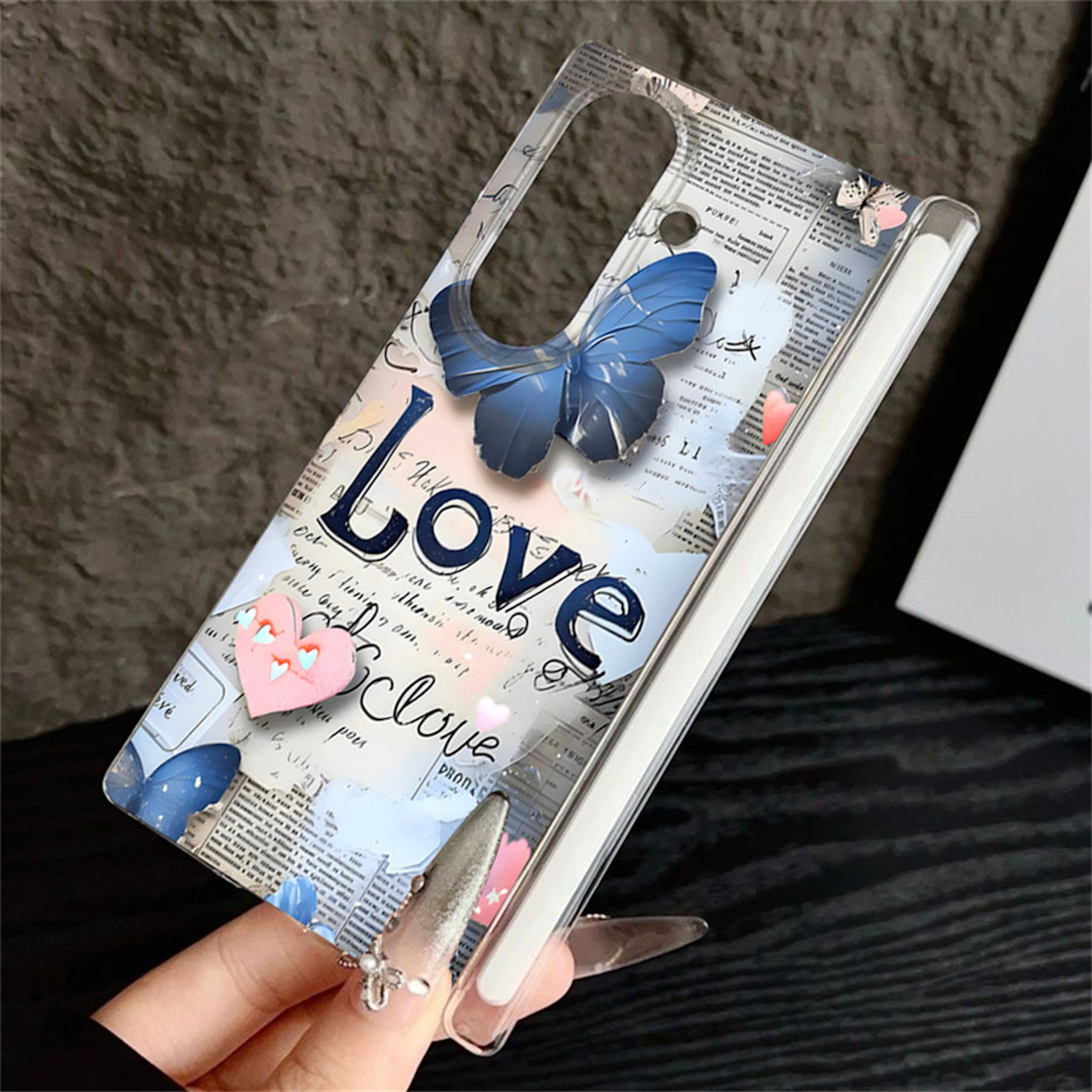 Transparente Handyhülle mit blauem Schmetterling, Zeitungsmotiv und dem Wort Love auf dunklem Untergrund.