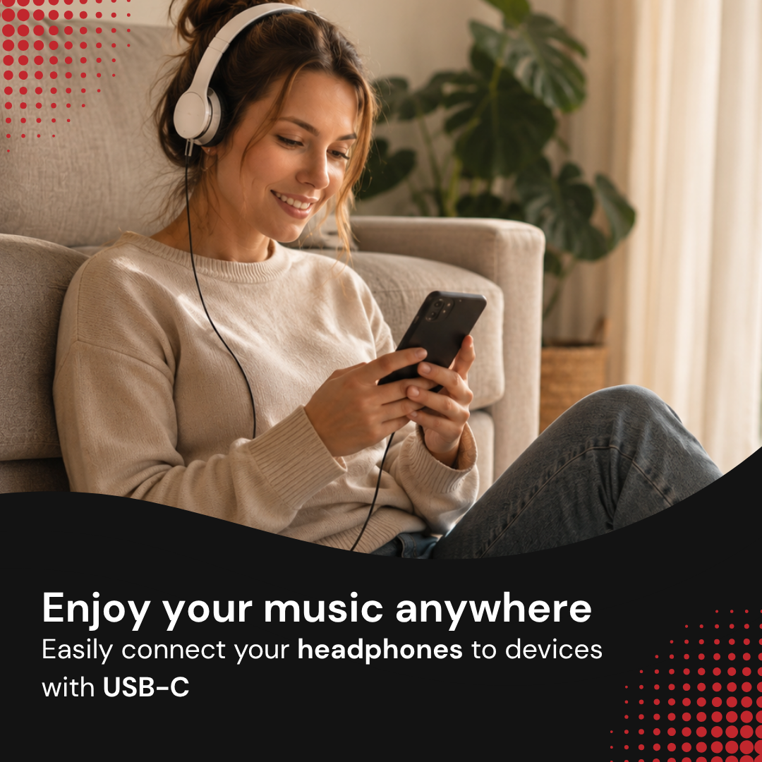 A young woman sitting on the floor wearing white headphones and smiling while looking at her smartphone.