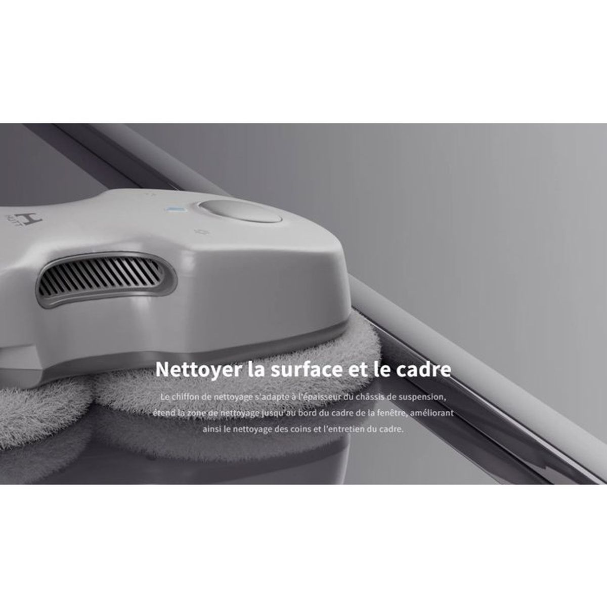 Un pulitore per finestre robotico grigio con cuscinetti rotondi pulisce una superficie di vetro vicino a un telaio.