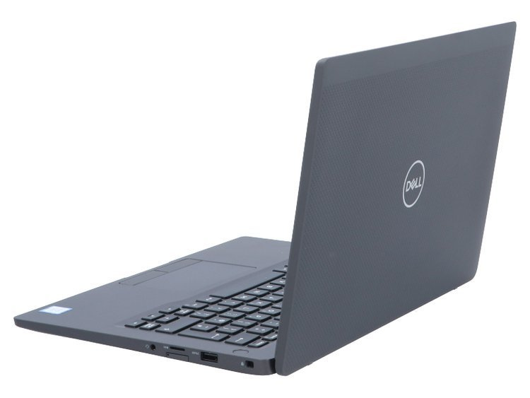 Szary laptop Dell jest otwarty na białej powierzchni, pokazując prawą stronę z portami.