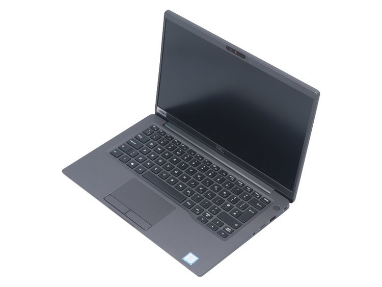 Szary laptop jest otwarty na białej powierzchni z czarną klawiaturą.