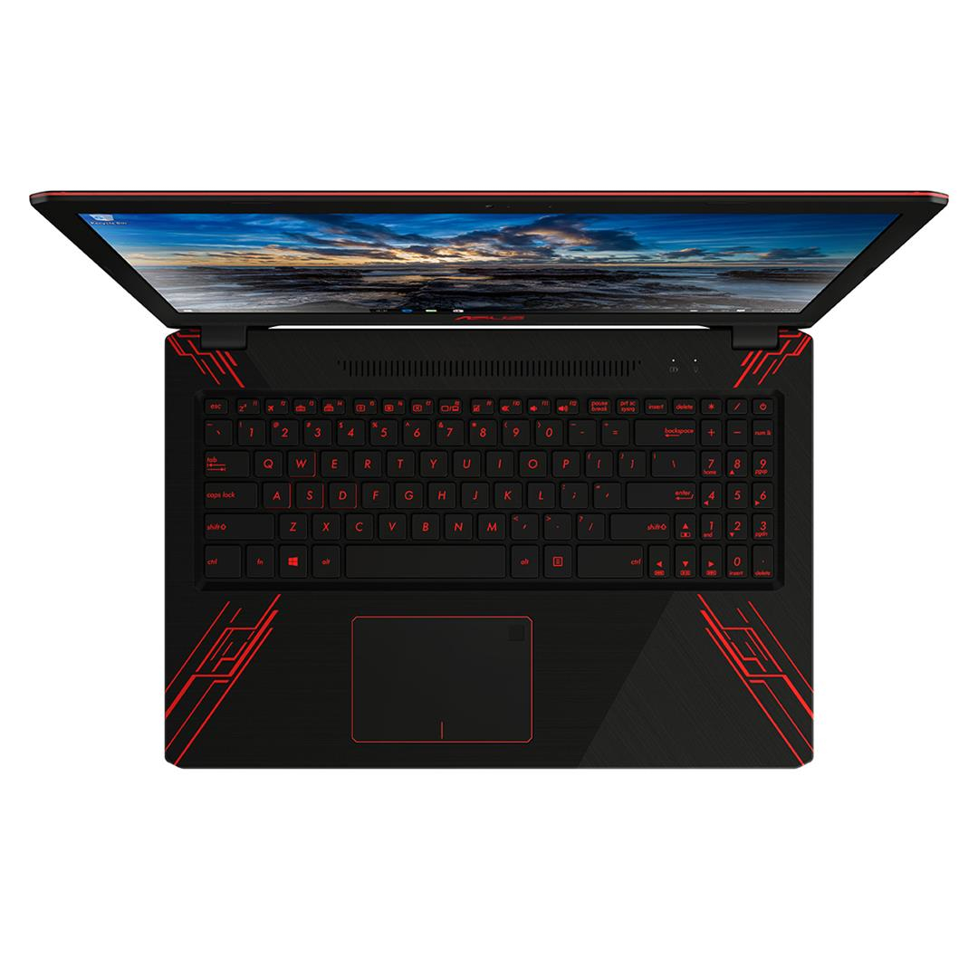 Ein schwarzer Laptop mit roten Akzenten, einer beleuchteten Tastatur und einem Display mit Naturszene.