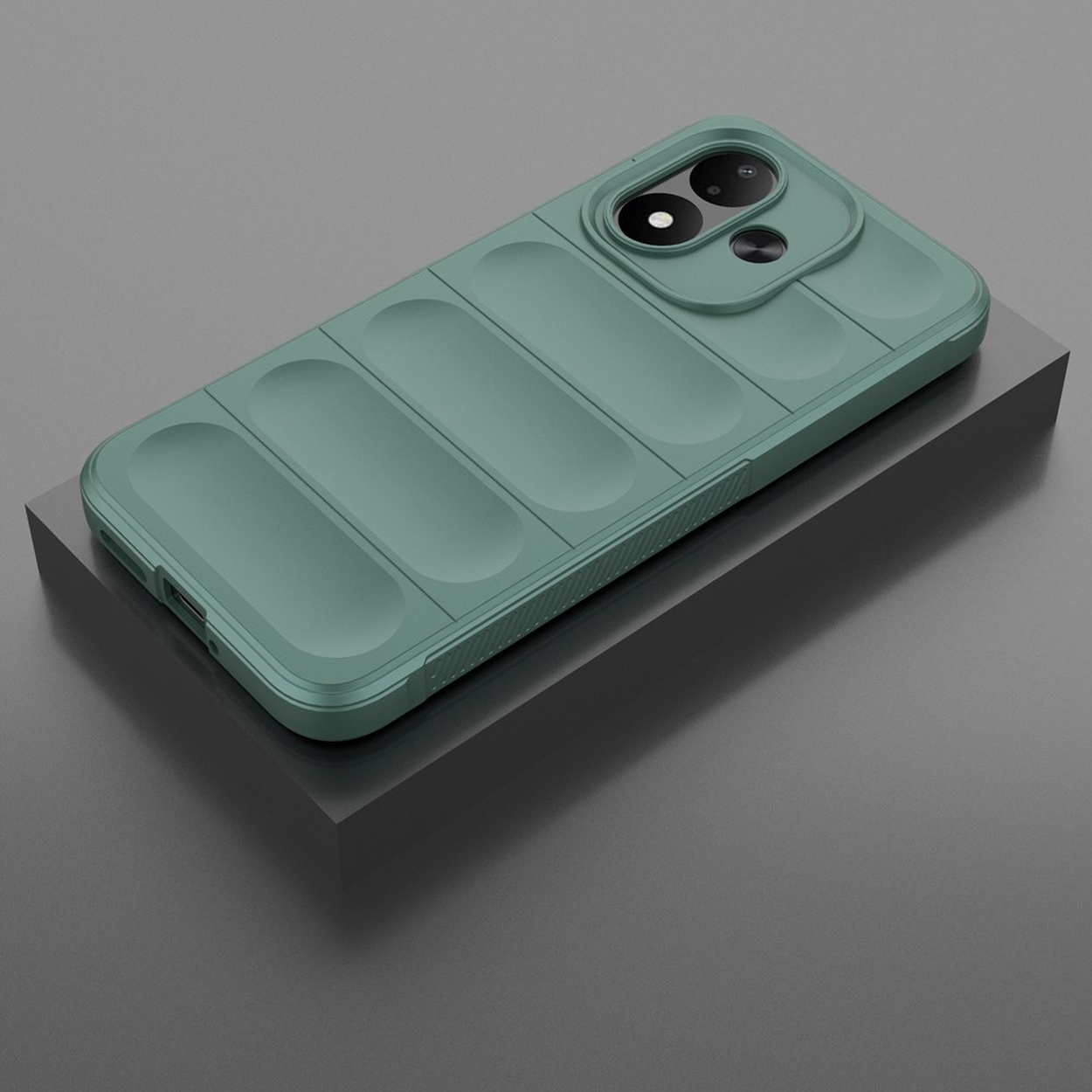 A green smartphone with a protective case rests diagonally on a gray pedestal.